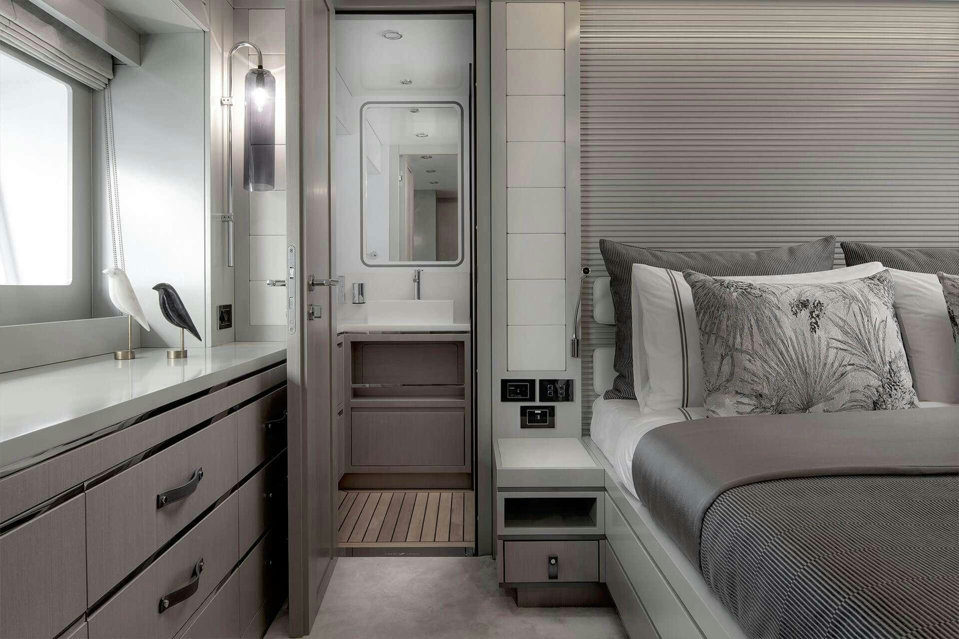 a bedroom with a bed and a closet aboard NORMAN'S T4 Yacht for Charter