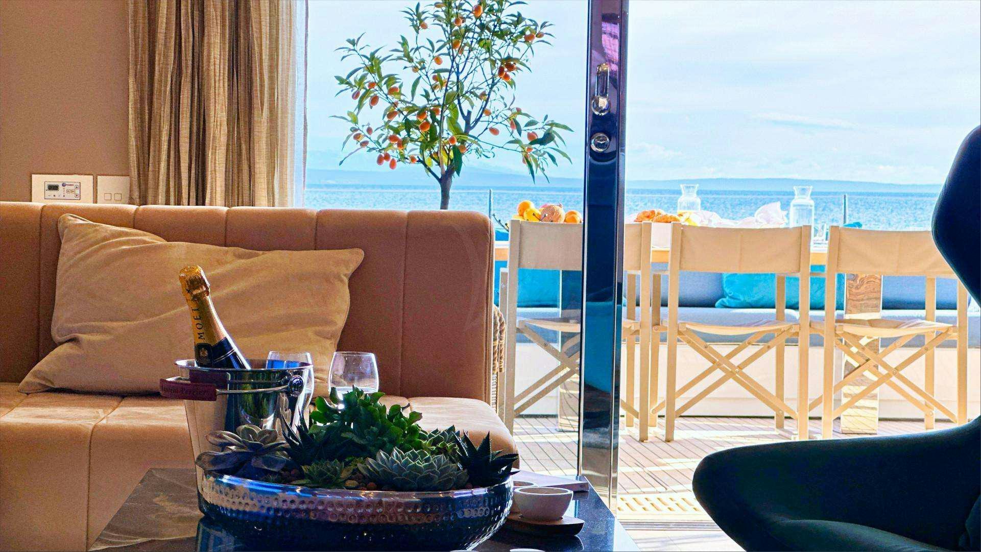 a living room with a table and chairs aboard NALA ONE Yacht for Charter