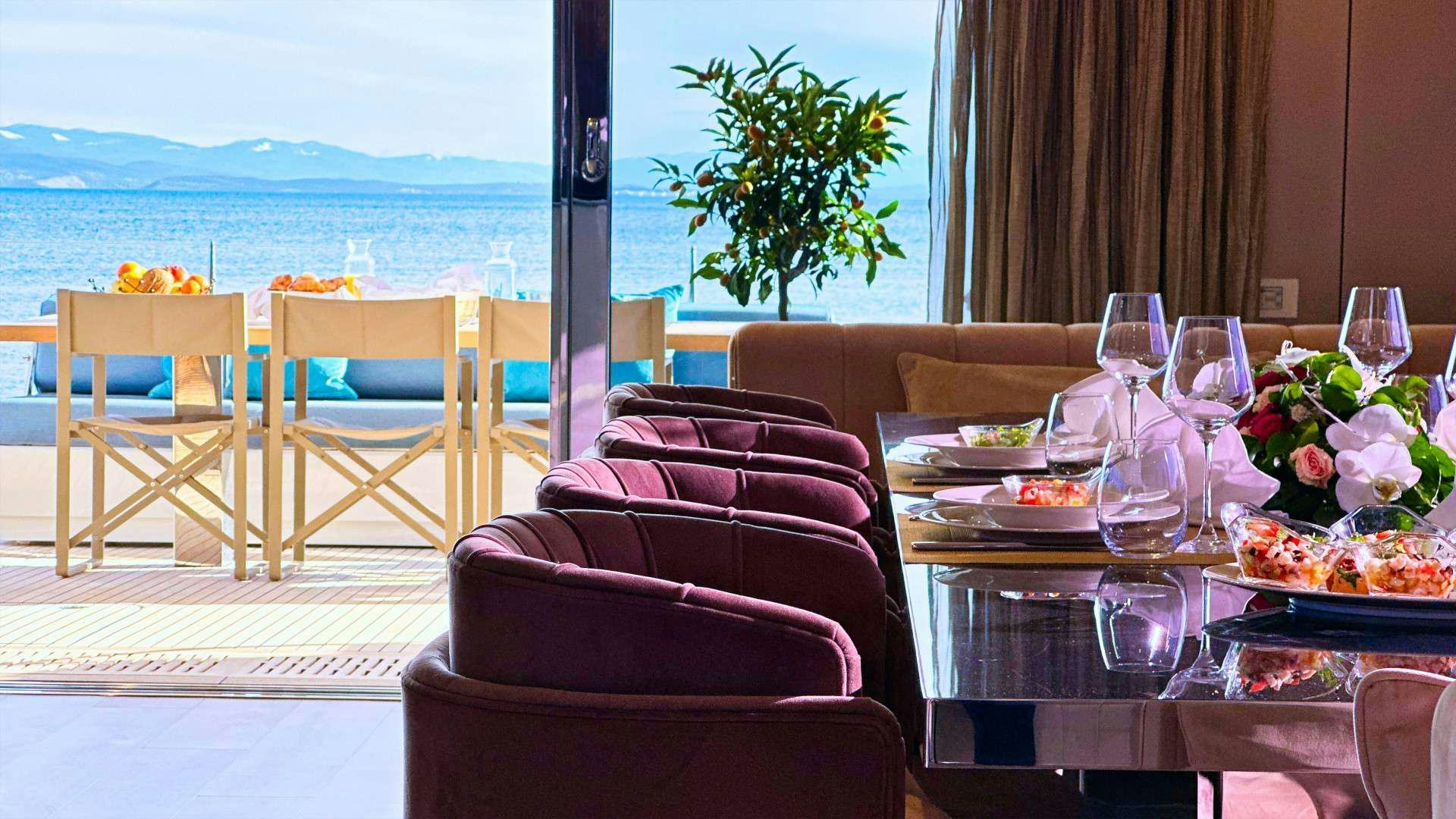 a table with wine glasses on it aboard NALA ONE Yacht for Charter