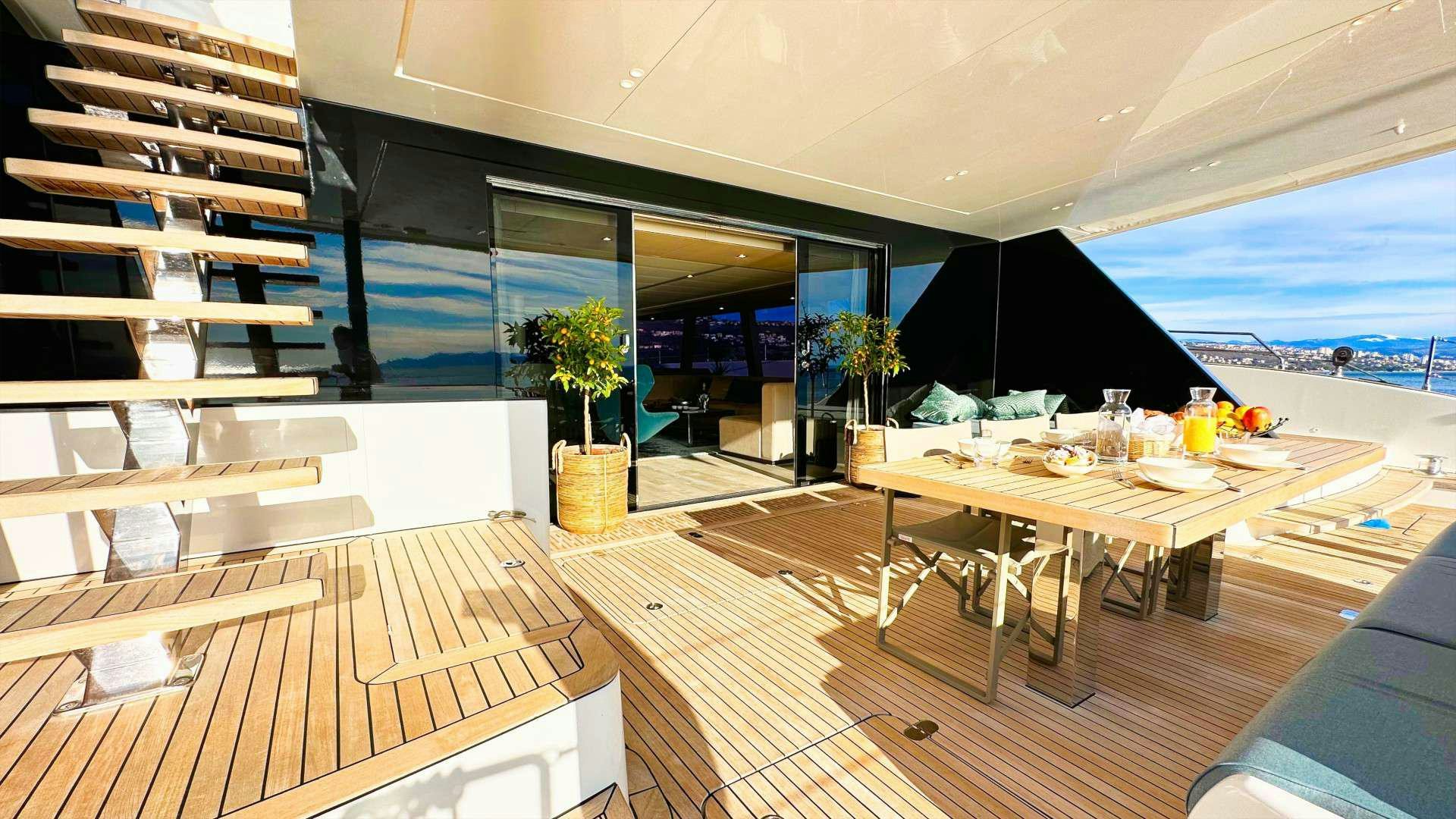 a room with a table and chairs aboard NALA ONE Yacht for Charter