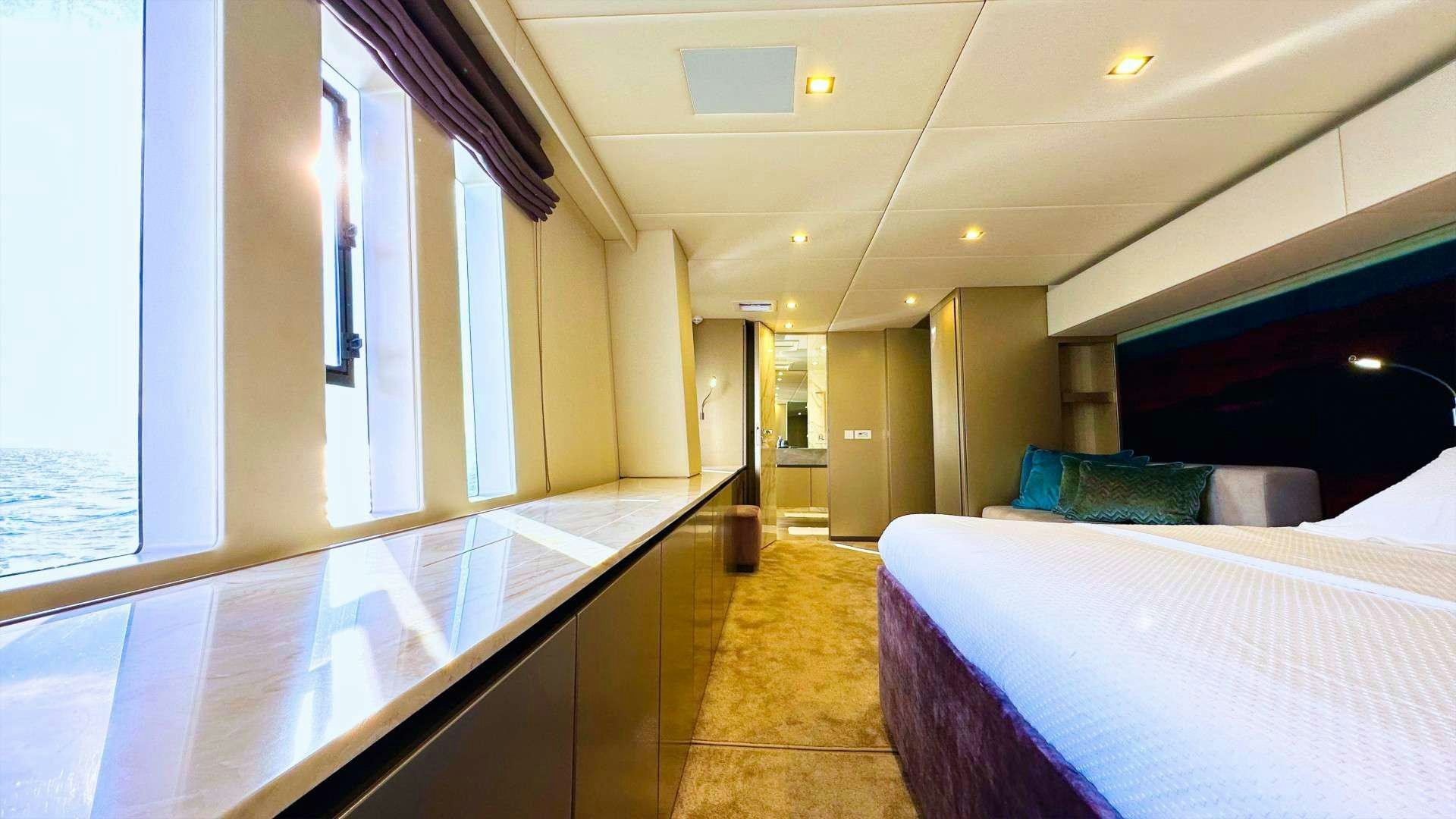 a room with a bed and a desk aboard NALA ONE Yacht for Charter