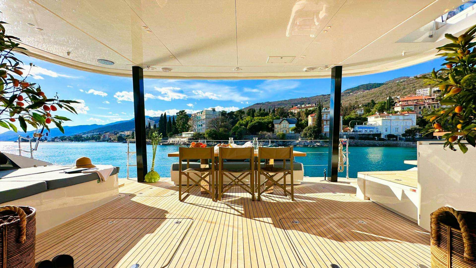 a room with a table and chairs aboard NALA ONE Yacht for Charter