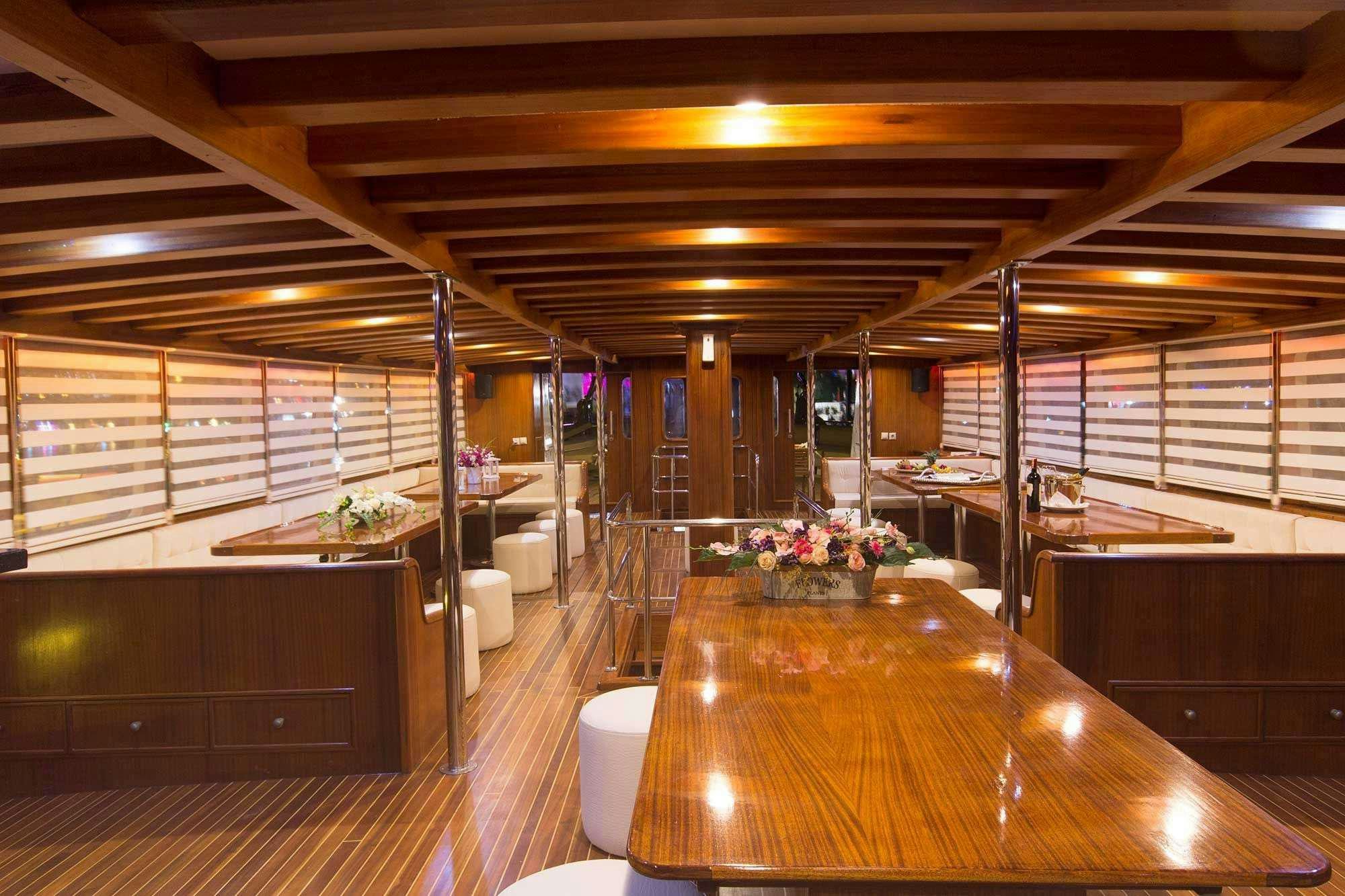a large room with a table and chairs aboard BOREAS Yacht for Charter