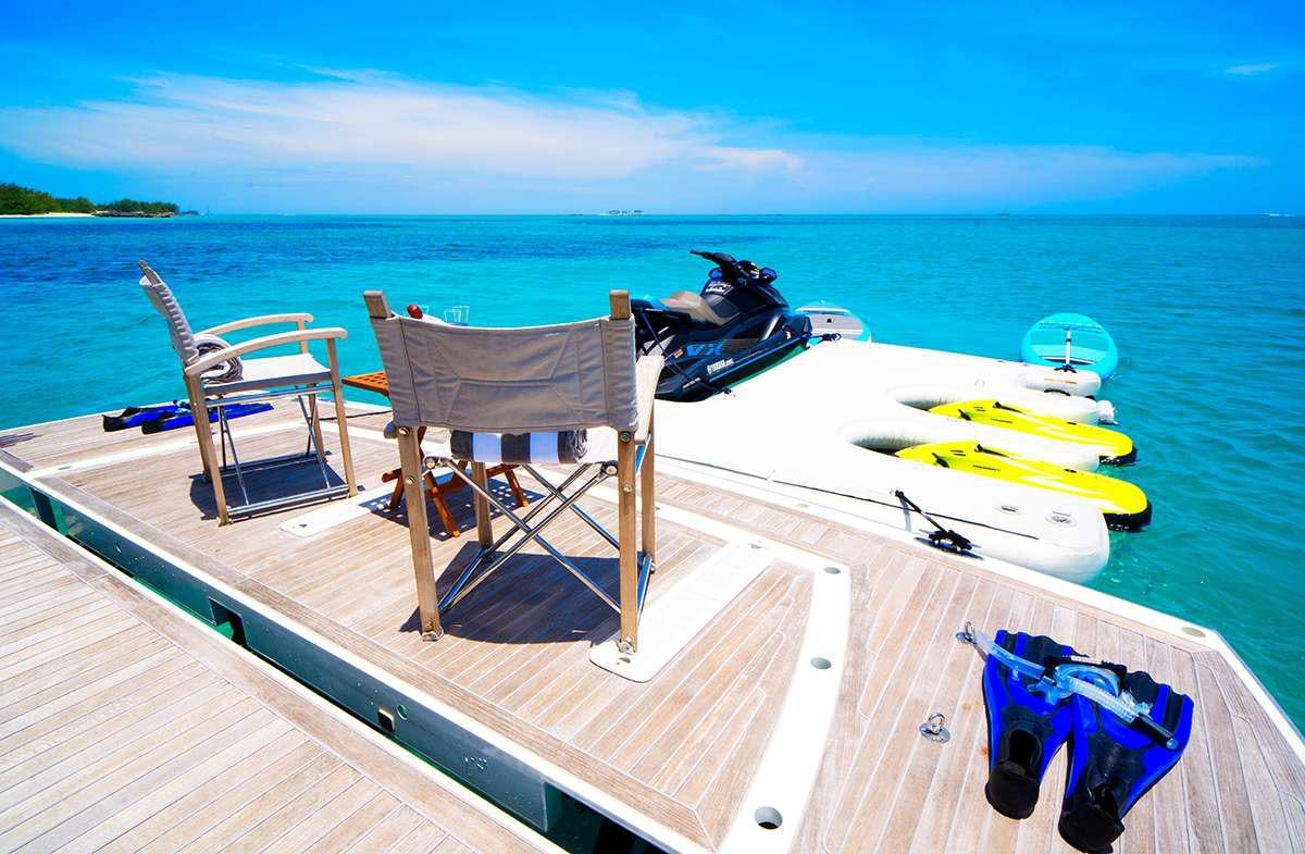 a chair and a table on a boat on a dock aboard DADDY'S $ Yacht for Charter