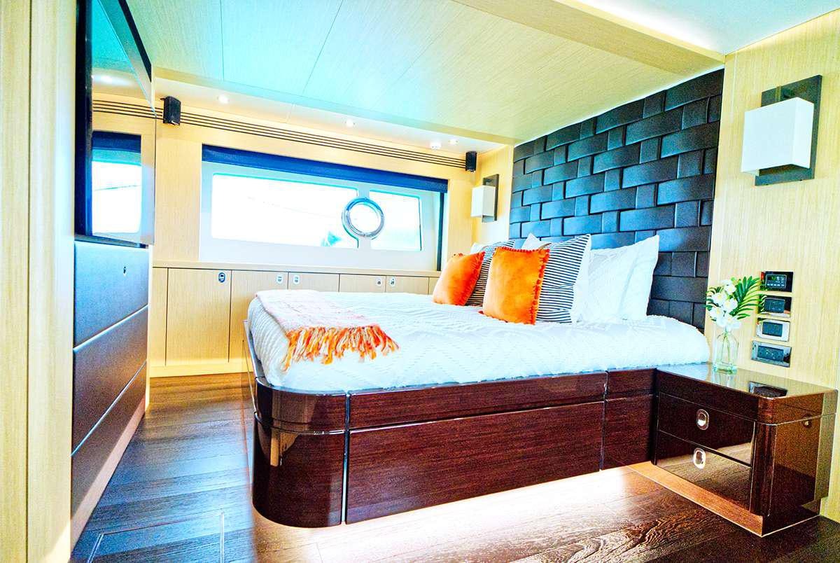 a bedroom with a bed and a desk aboard DADDY'S $ Yacht for Charter