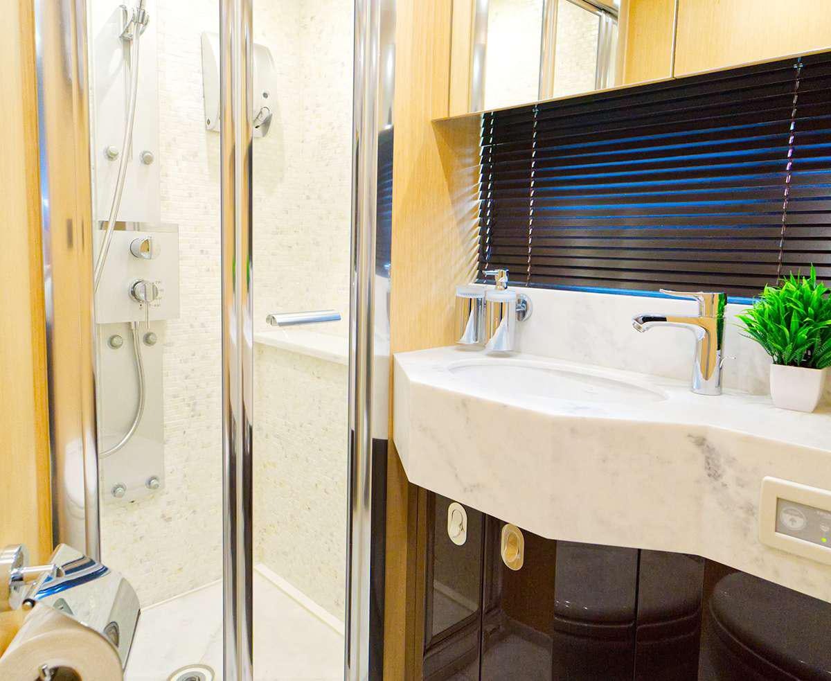 a bathroom with a sink and shower aboard DADDY'S $ Yacht for Charter