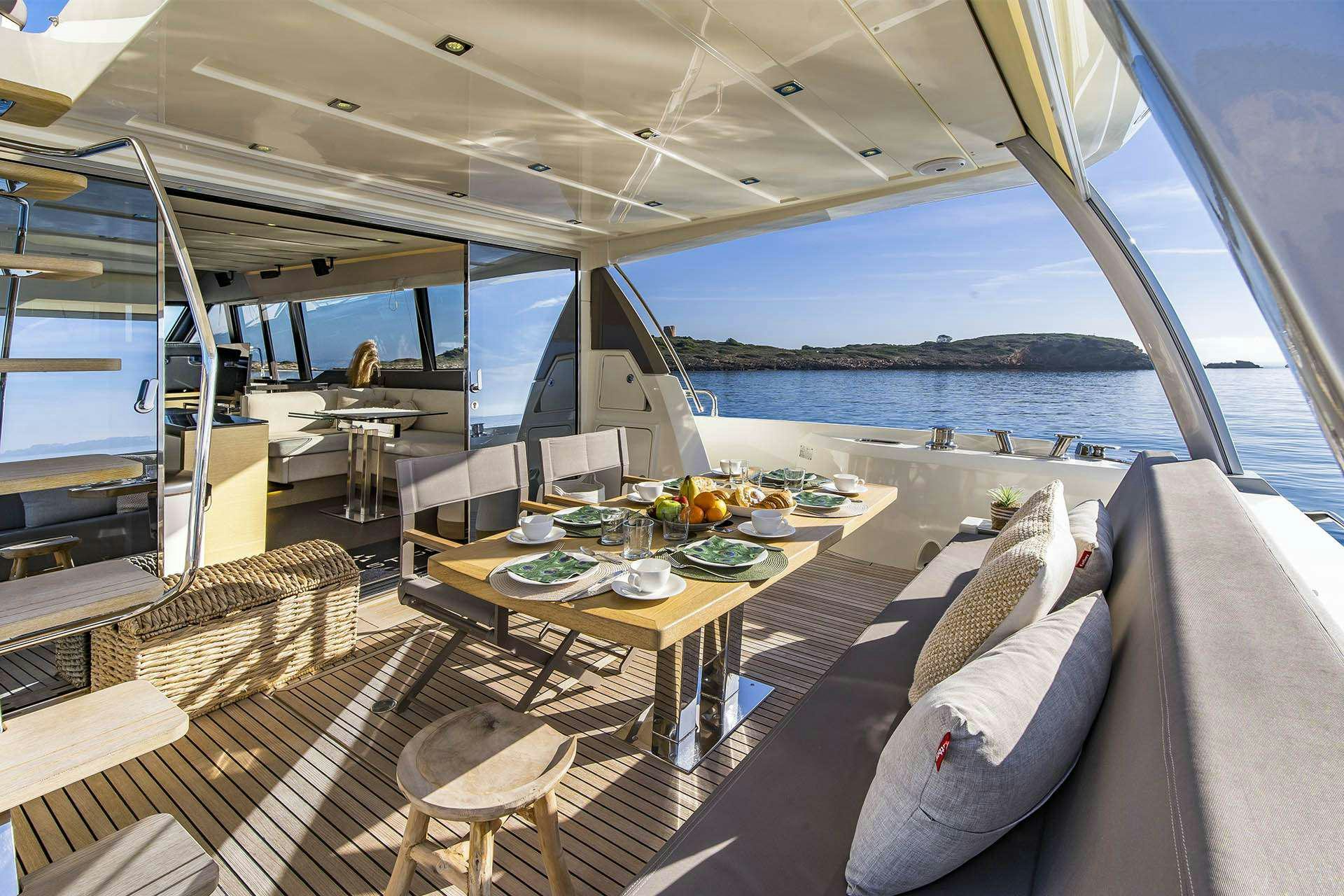 a boat with a table and chairs aboard BLUE M Yacht for Charter