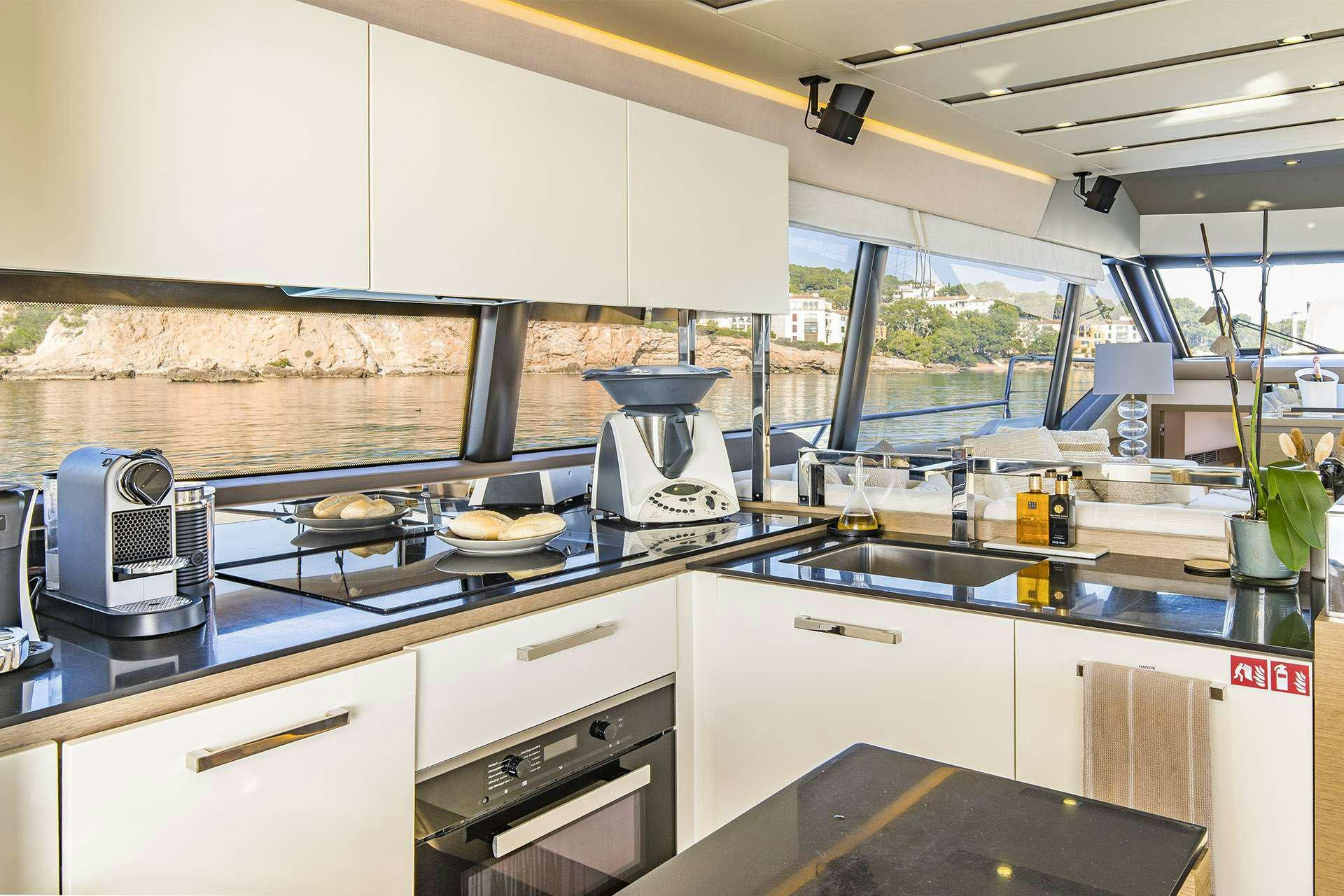 a kitchen with white cabinets aboard BLUE M Yacht for Charter