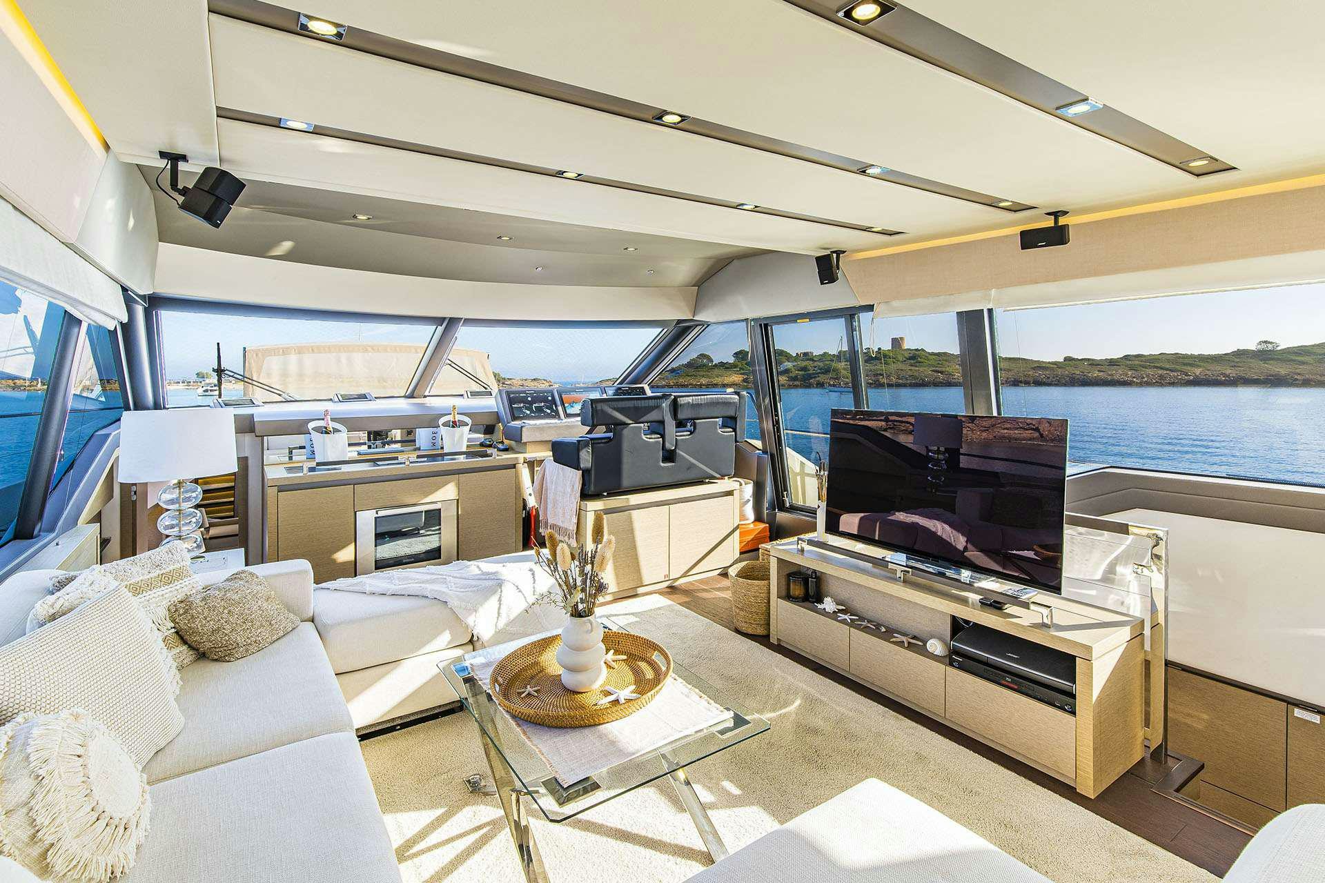 a living room with a large window aboard BLUE M Yacht for Charter