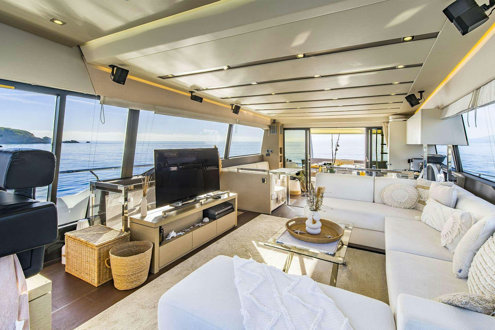 a living room with a large window aboard BLUE M Yacht for Charter