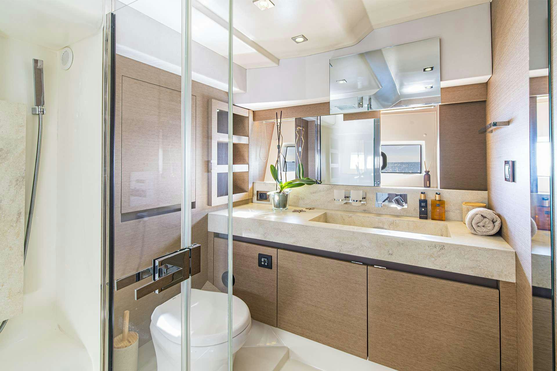 a bathroom with a glass shower door aboard BLUE M Yacht for Charter