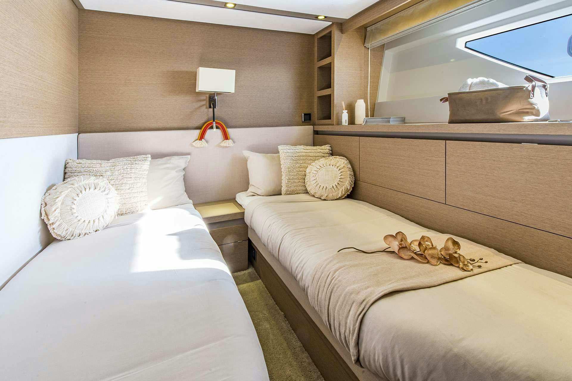 a room with two beds aboard BLUE M Yacht for Charter