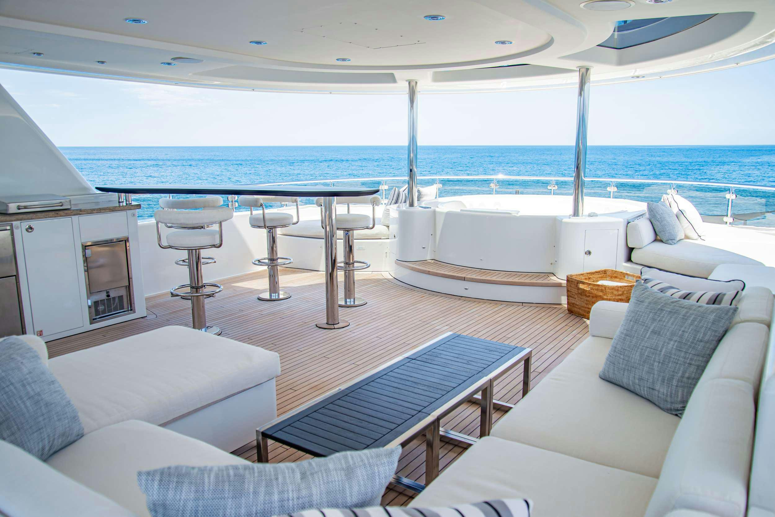 a large living room with a large balcony overlooking the ocean aboard RULE NO. 1 Yacht for Charter