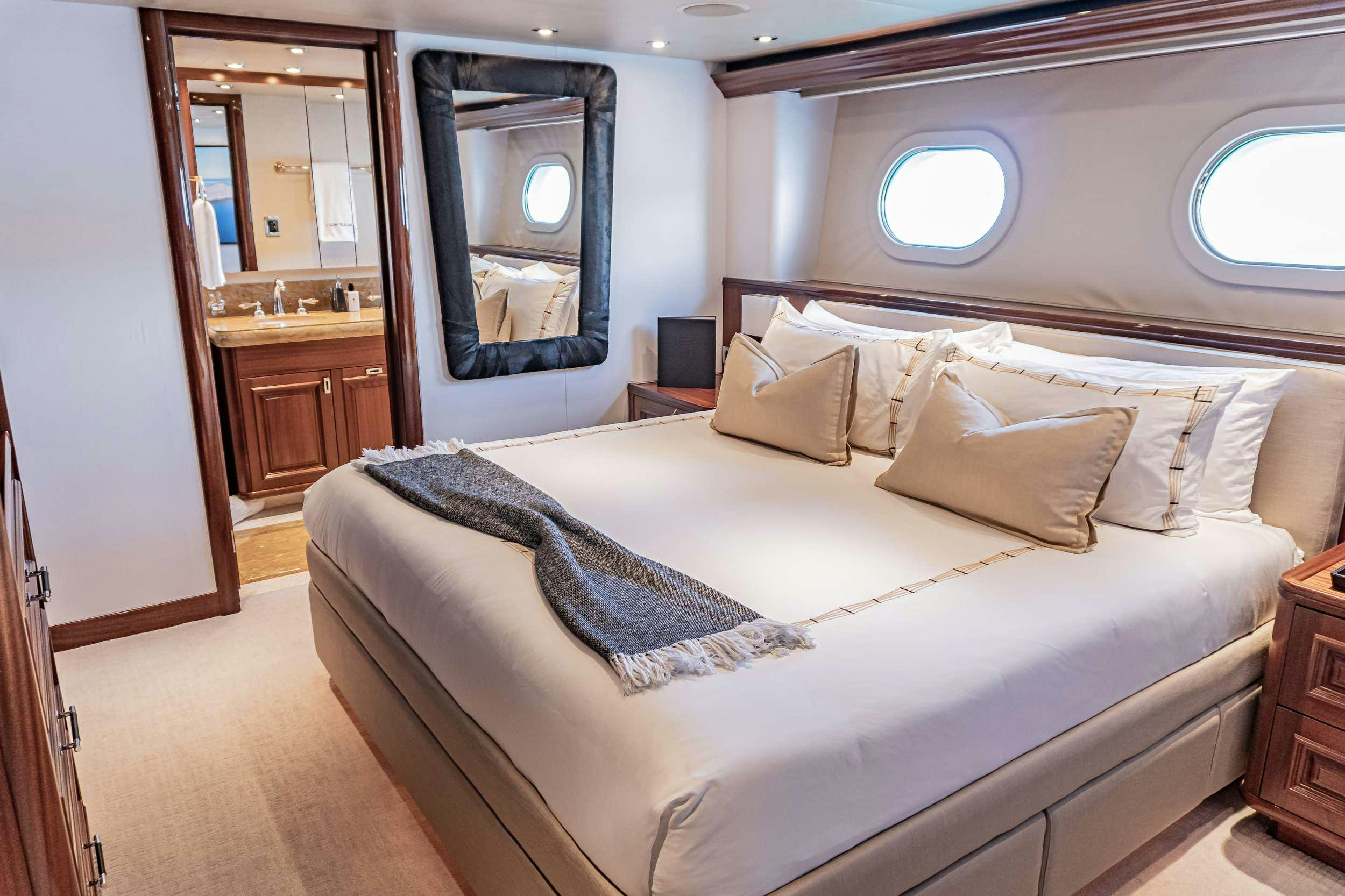 a bed with white sheets aboard RULE NO. 1 Yacht for Charter