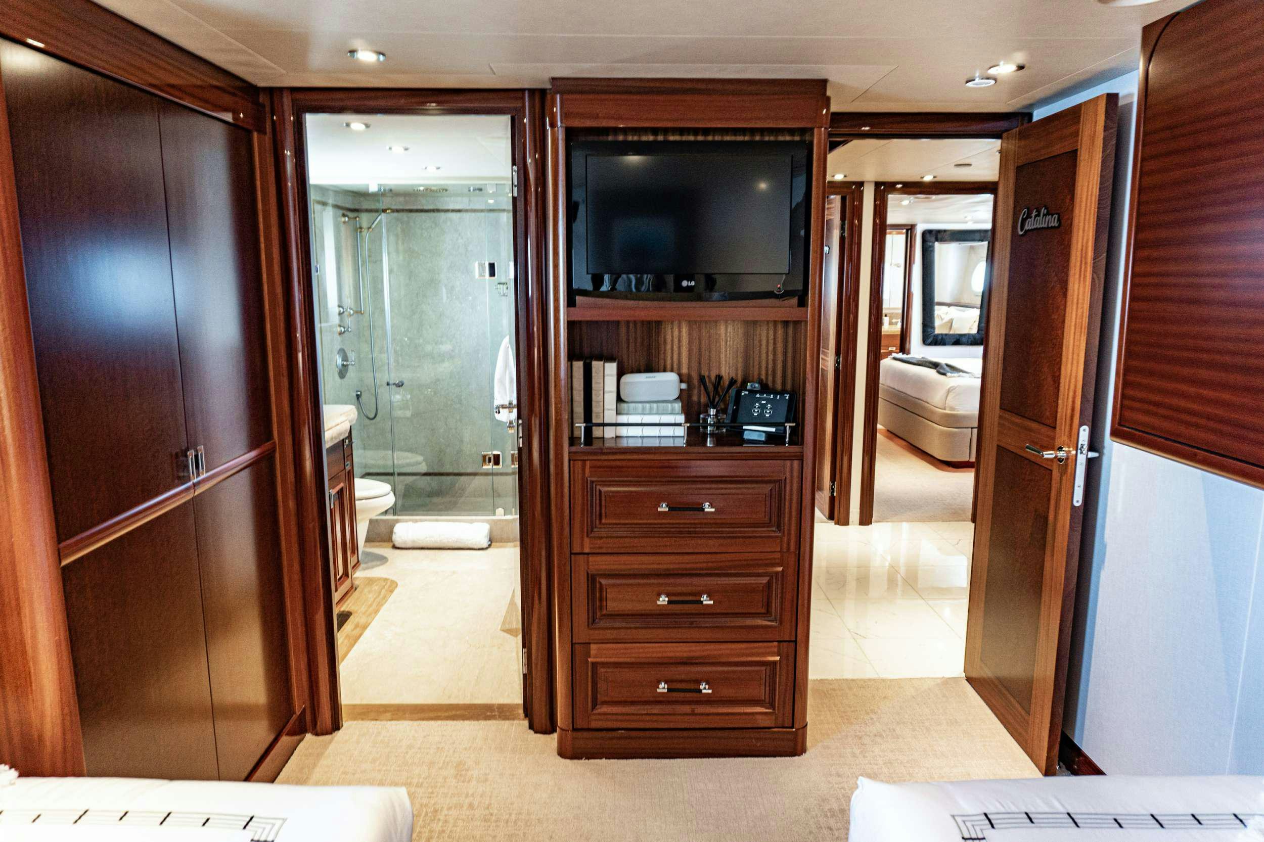 a room with a wood cabinet and a tv on the wall aboard RULE NO. 1 Yacht for Charter