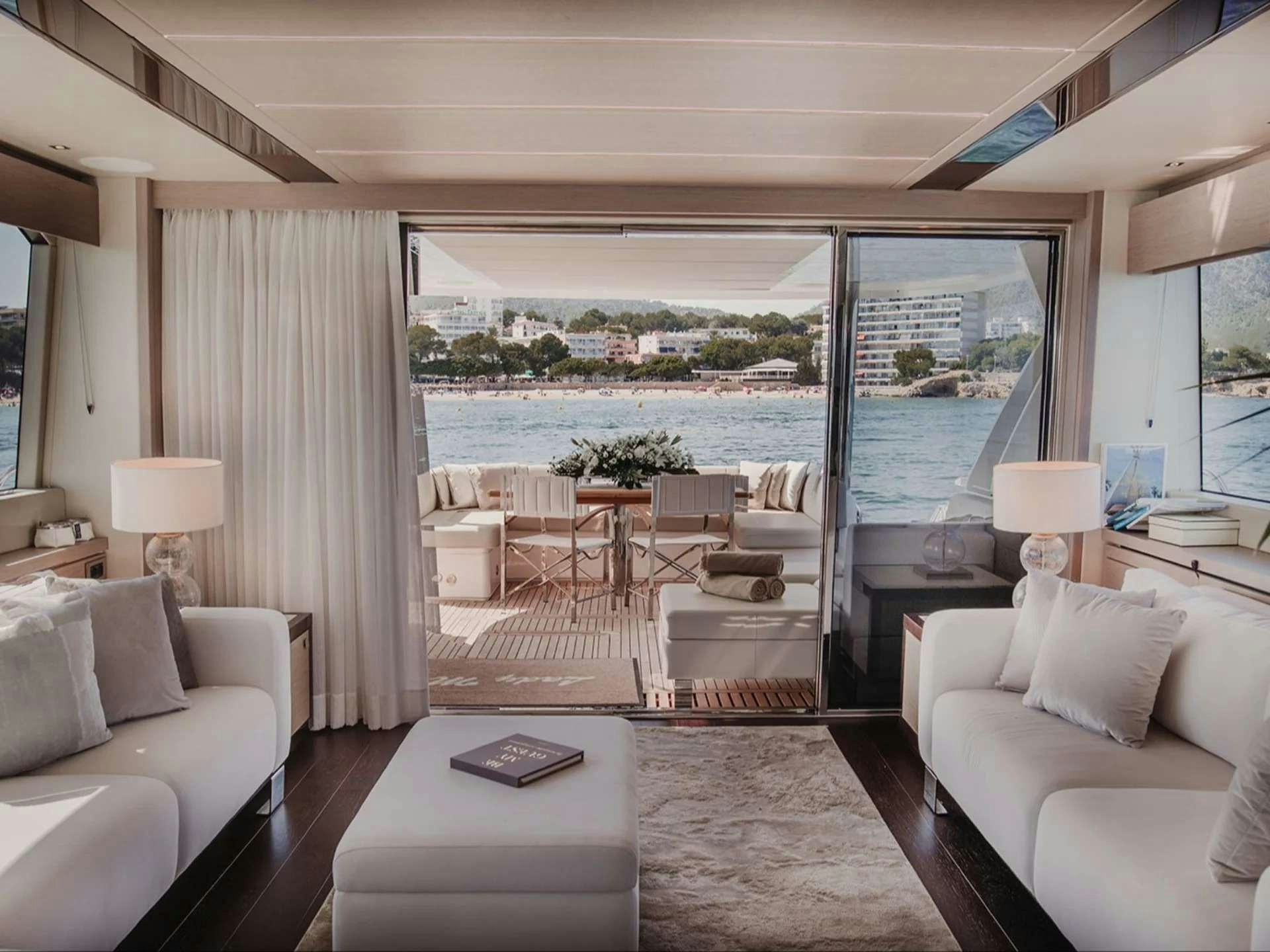 a living room with a large window aboard LADY M Yacht for Charter