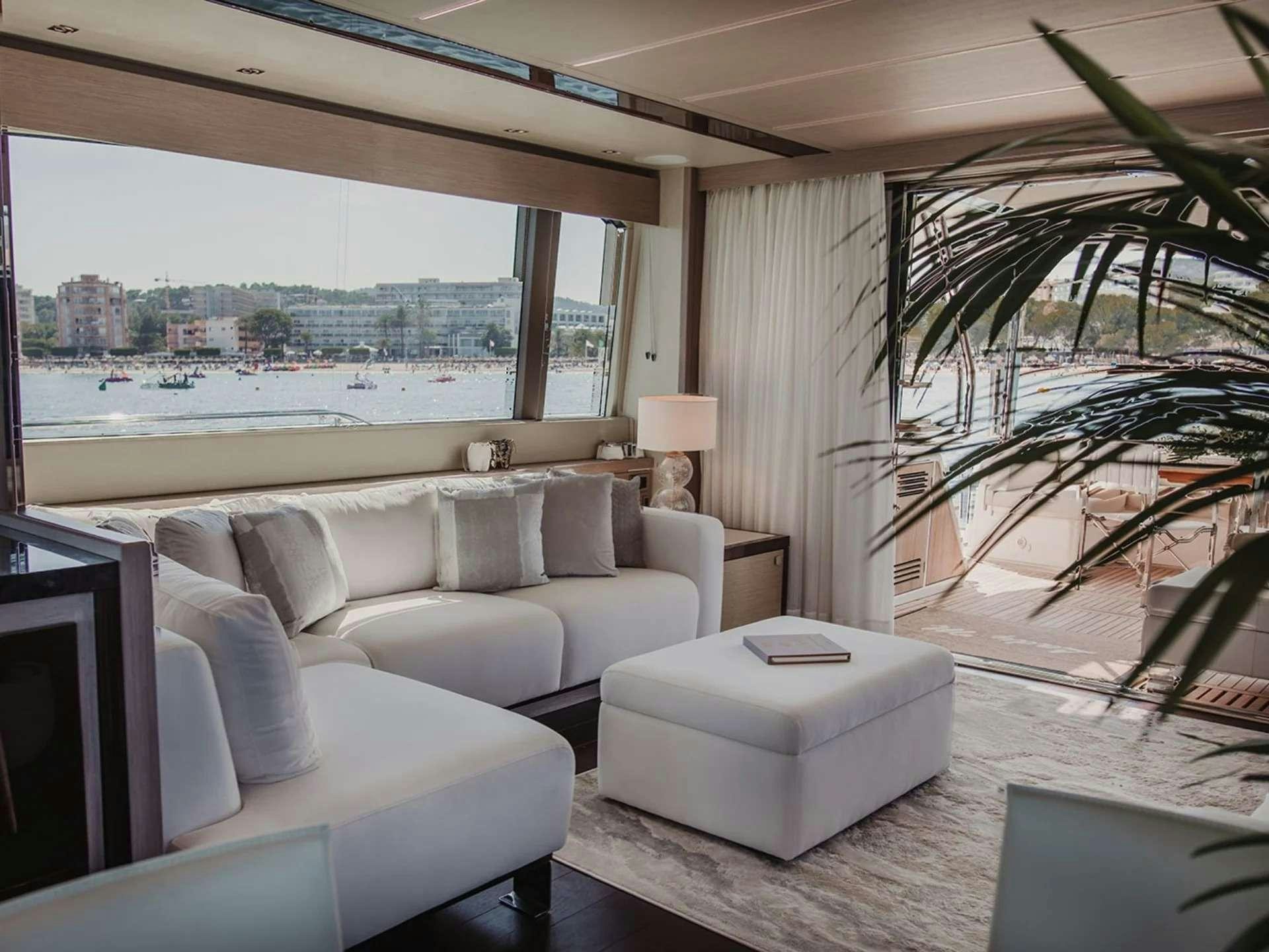 a living room with a large window aboard LADY M Yacht for Charter
