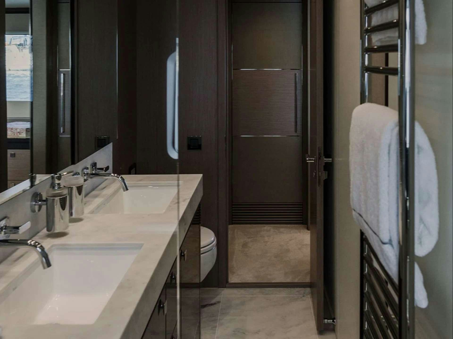 a bathroom with a sink and a toilet aboard LADY M Yacht for Charter