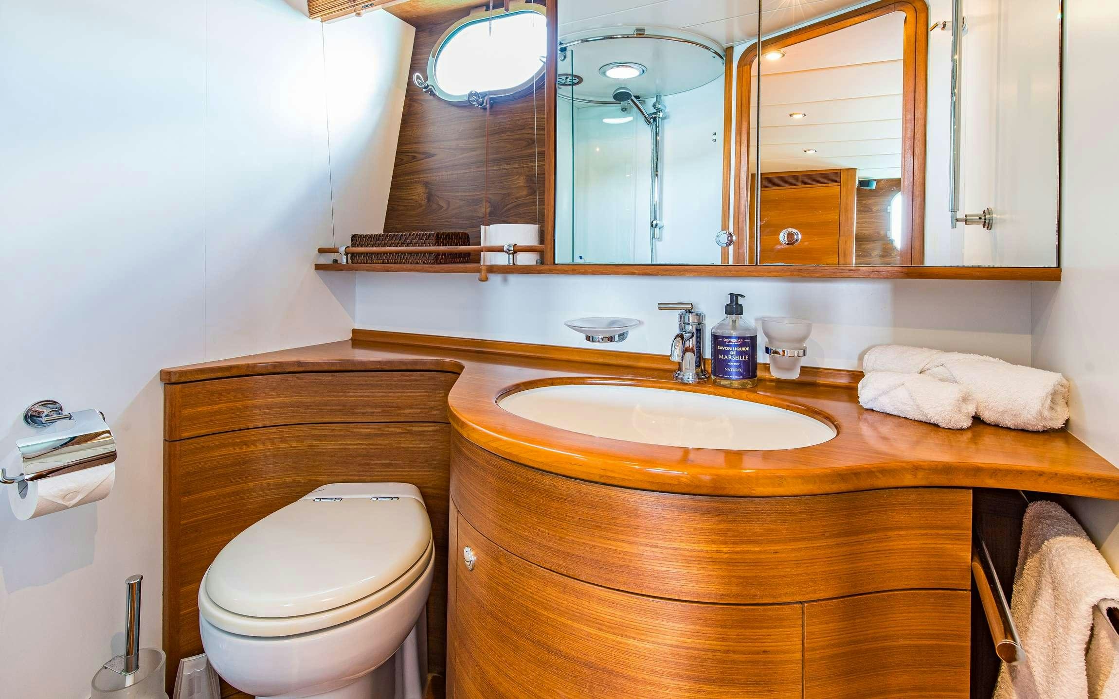 a bathroom with a sink and toilet aboard PARODIA Yacht for Charter