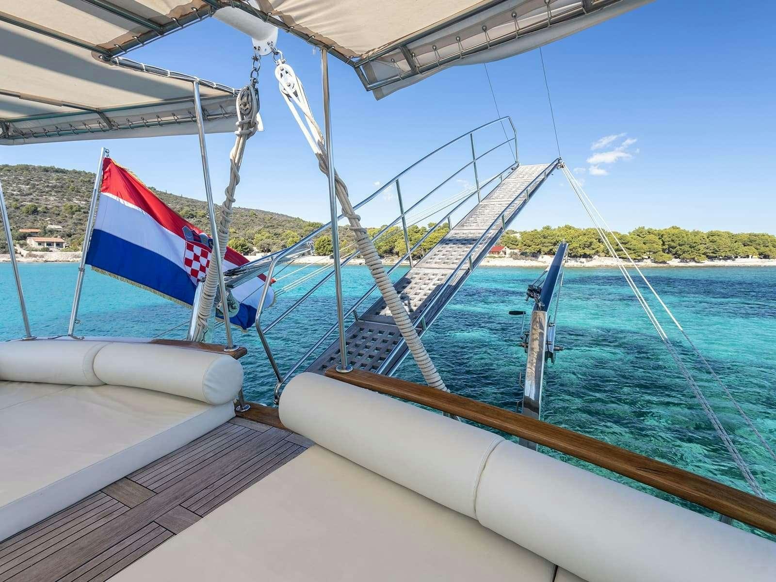 a boat with a flag on it aboard GULET ANDI STAR Yacht for Charter