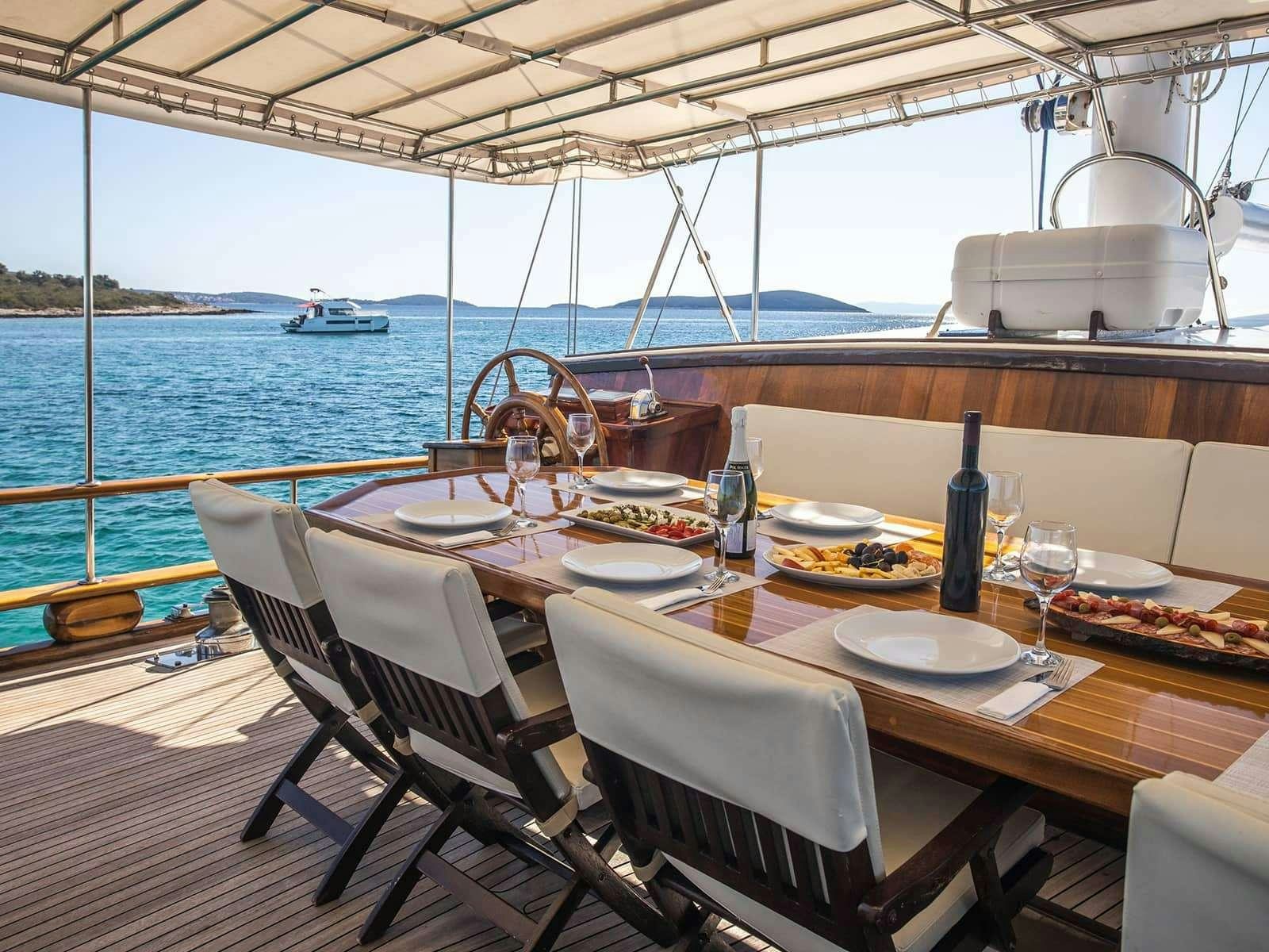 a table set for a meal on a boat aboard GULET ANDI STAR Yacht for Charter