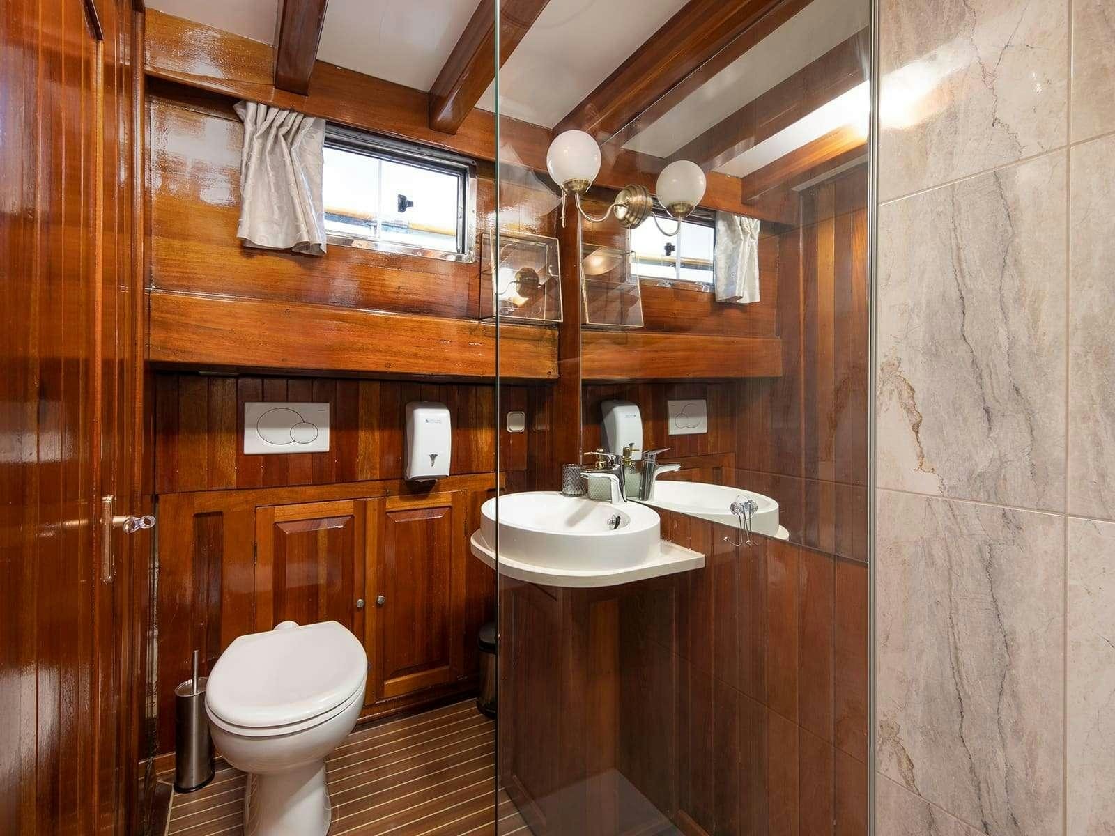 a bathroom with a sink toilet and a mirror aboard GULET ANDI STAR Yacht for Charter