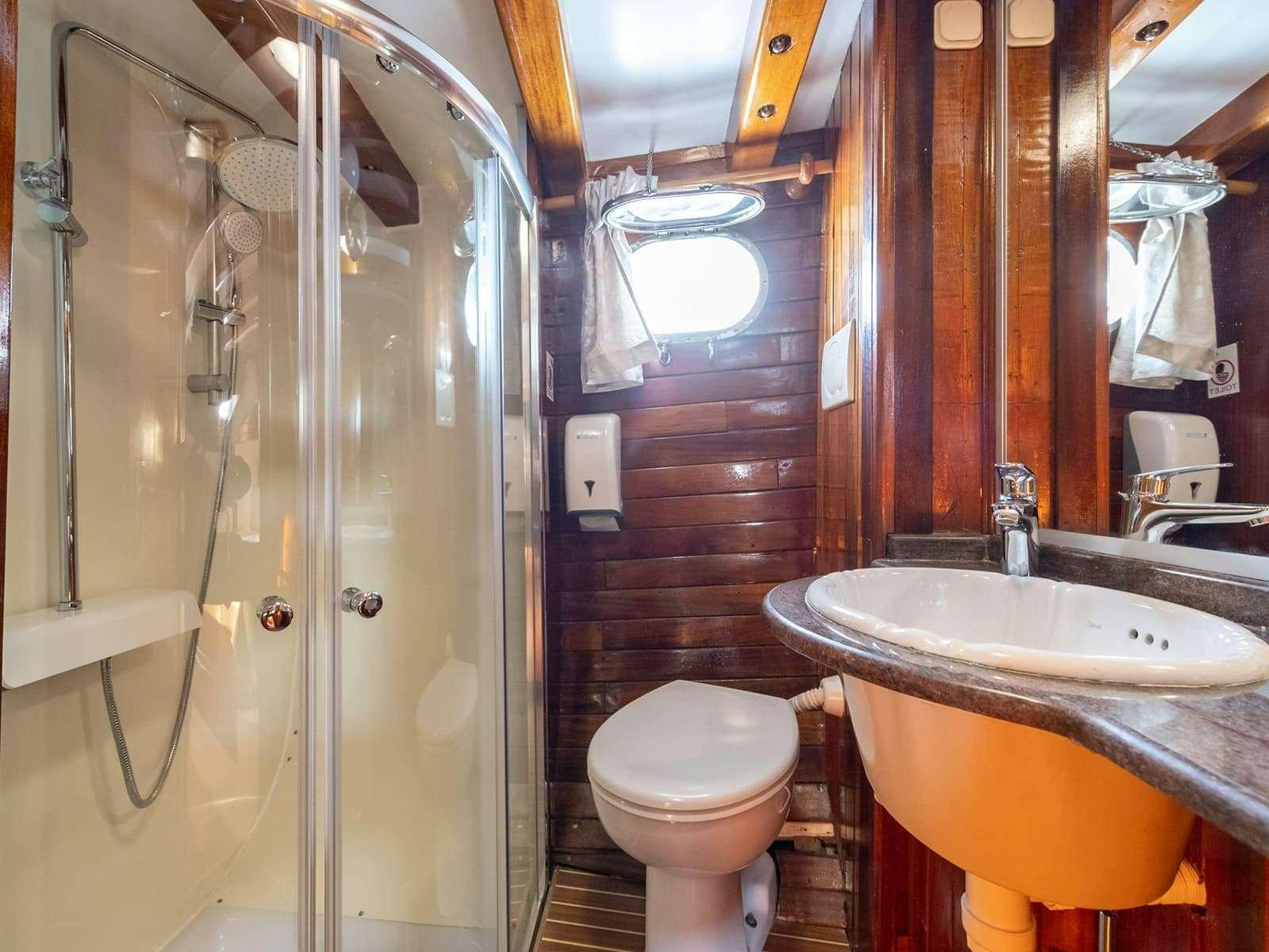 a bathroom with a sink toilet and shower aboard GULET ANDI STAR Yacht for Charter