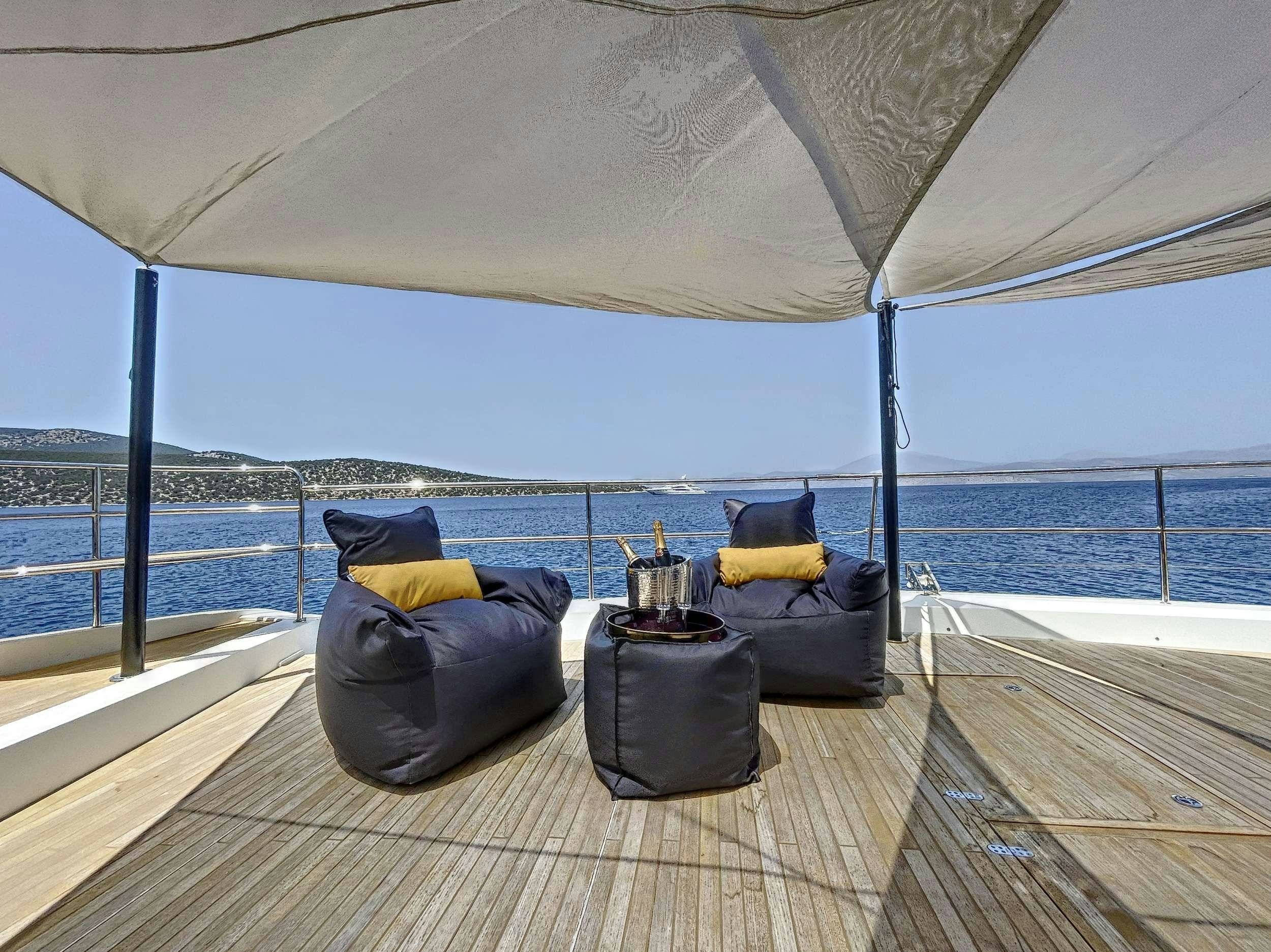 a couple of chairs under a tent aboard CRAZY HORSE Yacht for Charter