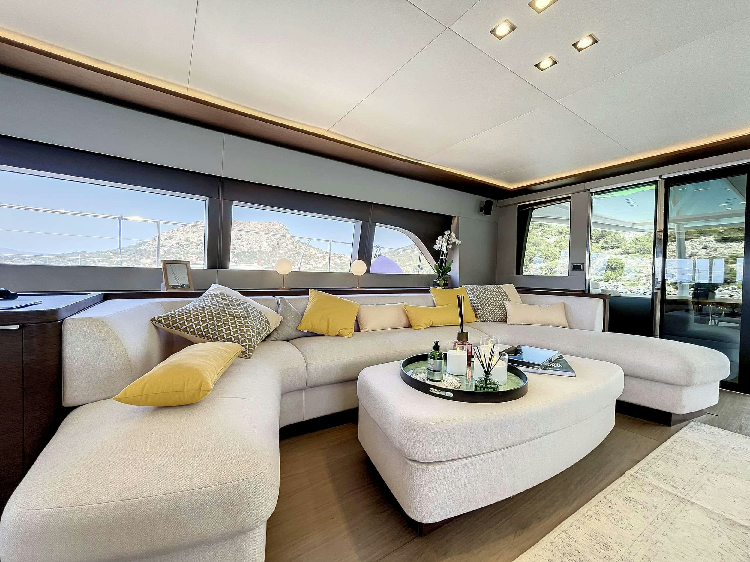 a modern living room with a large window aboard CRAZY HORSE Yacht for Charter