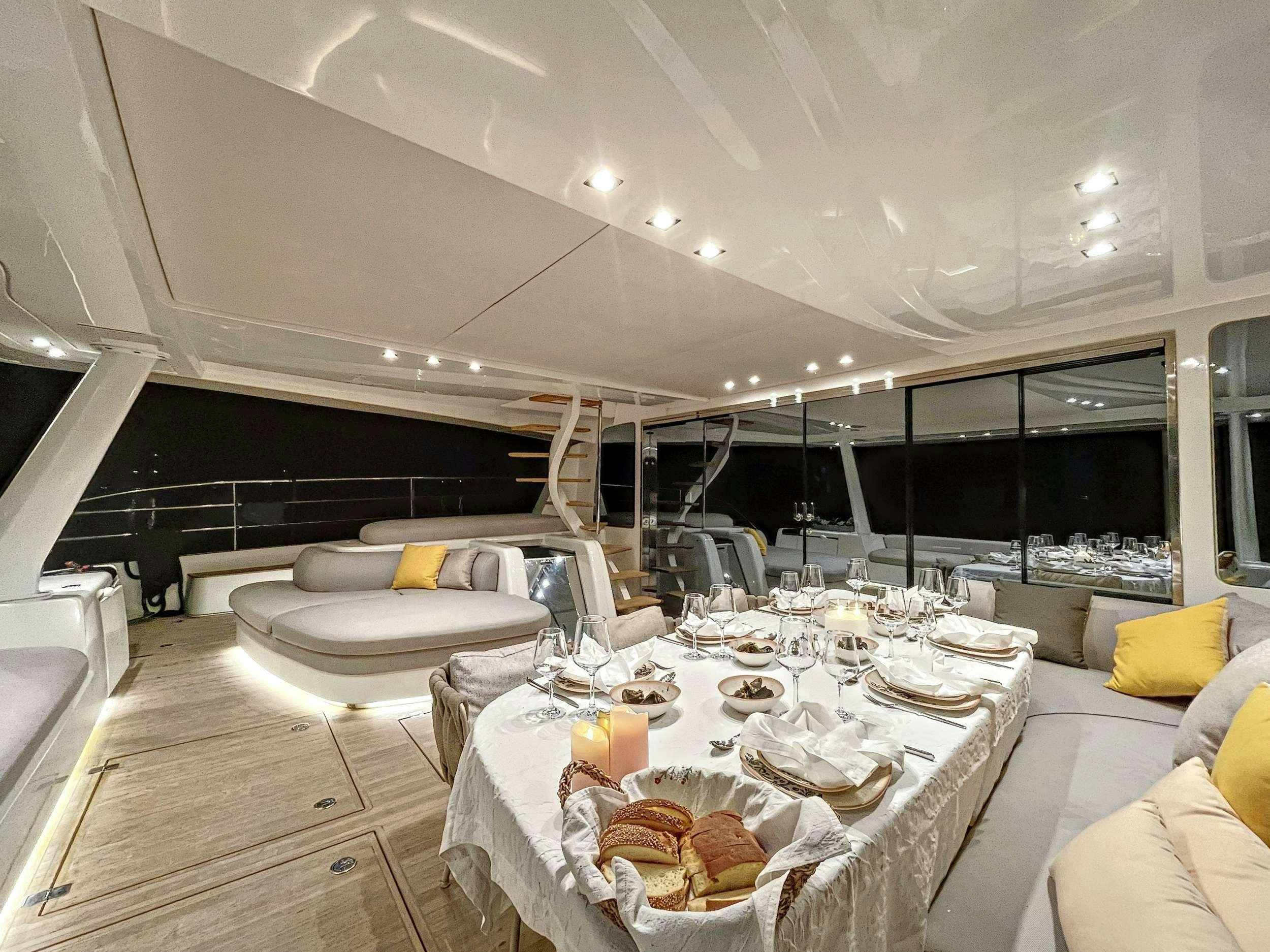 a large room with a table and chairs aboard CRAZY HORSE Yacht for Charter