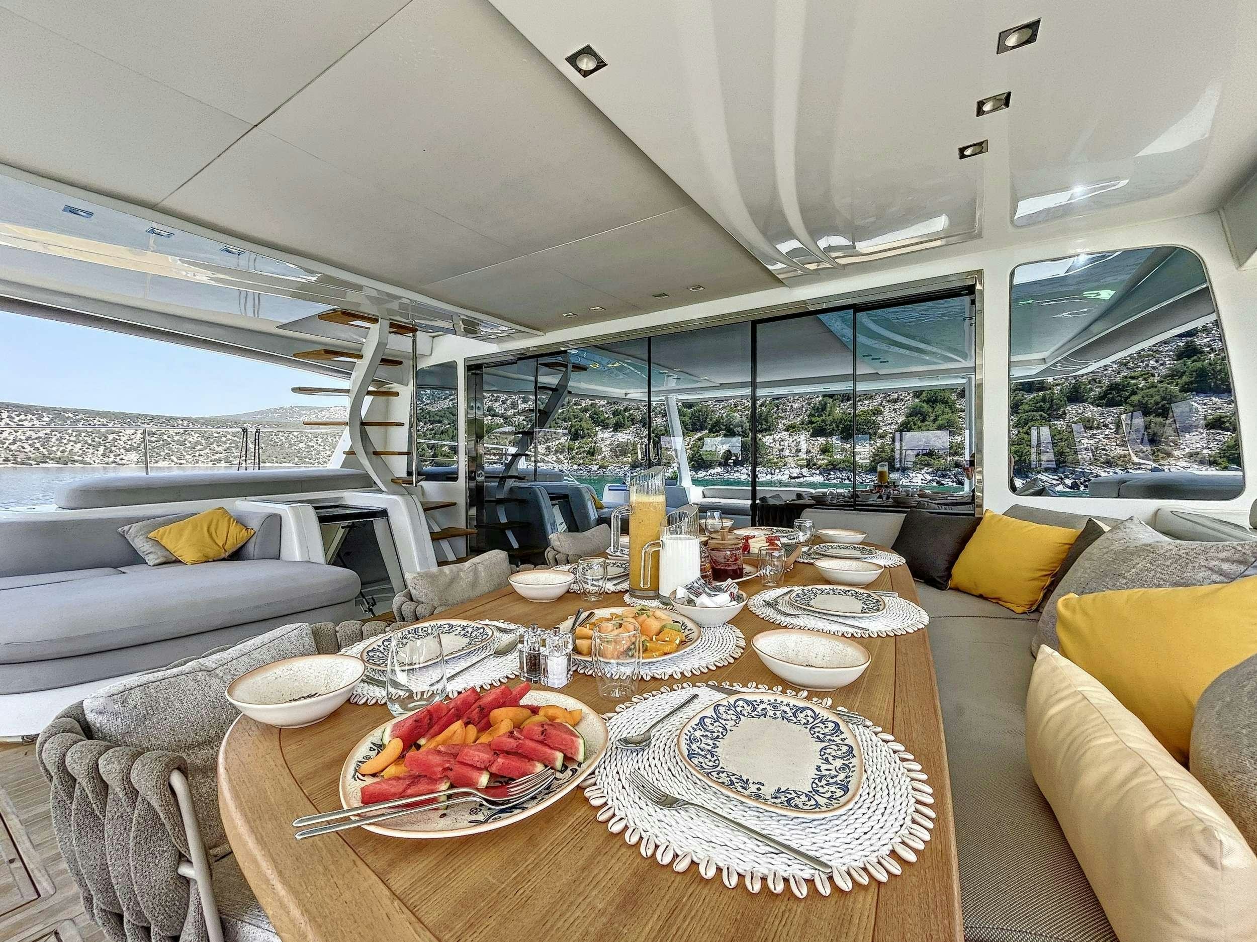 a table with plates and food on it aboard CRAZY HORSE Yacht for Charter