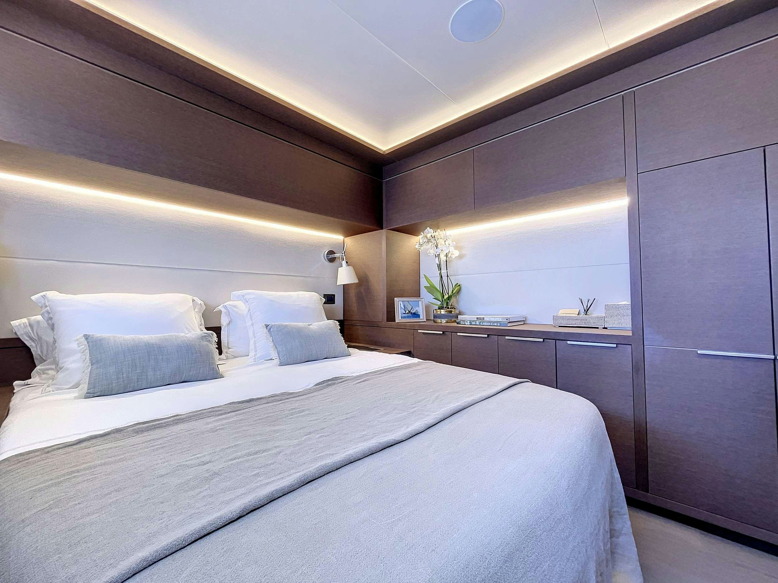 a bed with white sheets aboard CRAZY HORSE Yacht for Charter