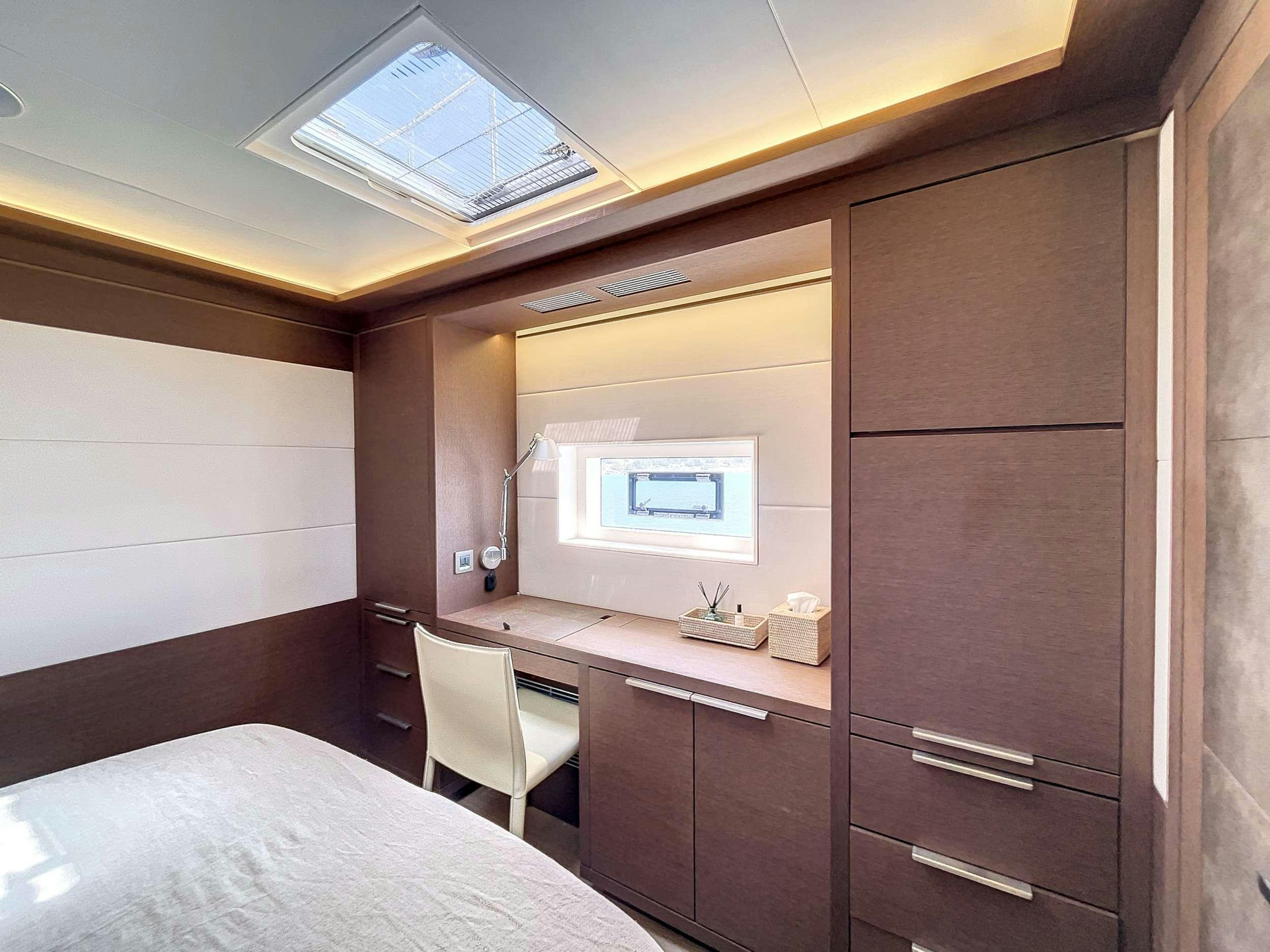 a room with a bed and a desk aboard CRAZY HORSE Yacht for Charter