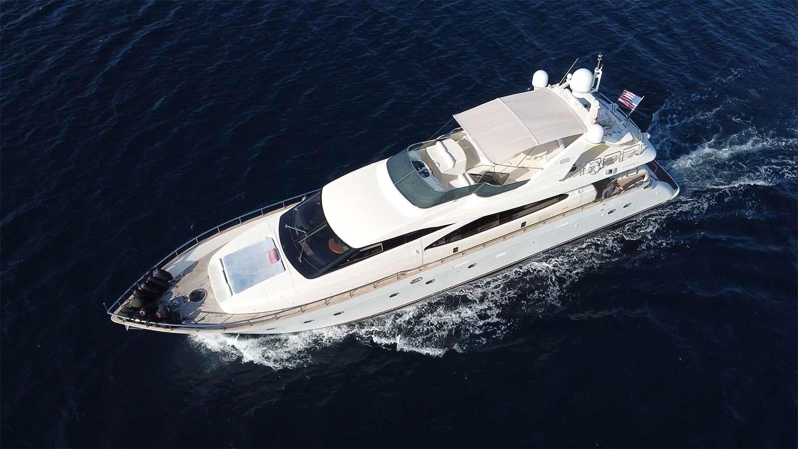 a white boat in the water aboard TITAN Yacht for Charter