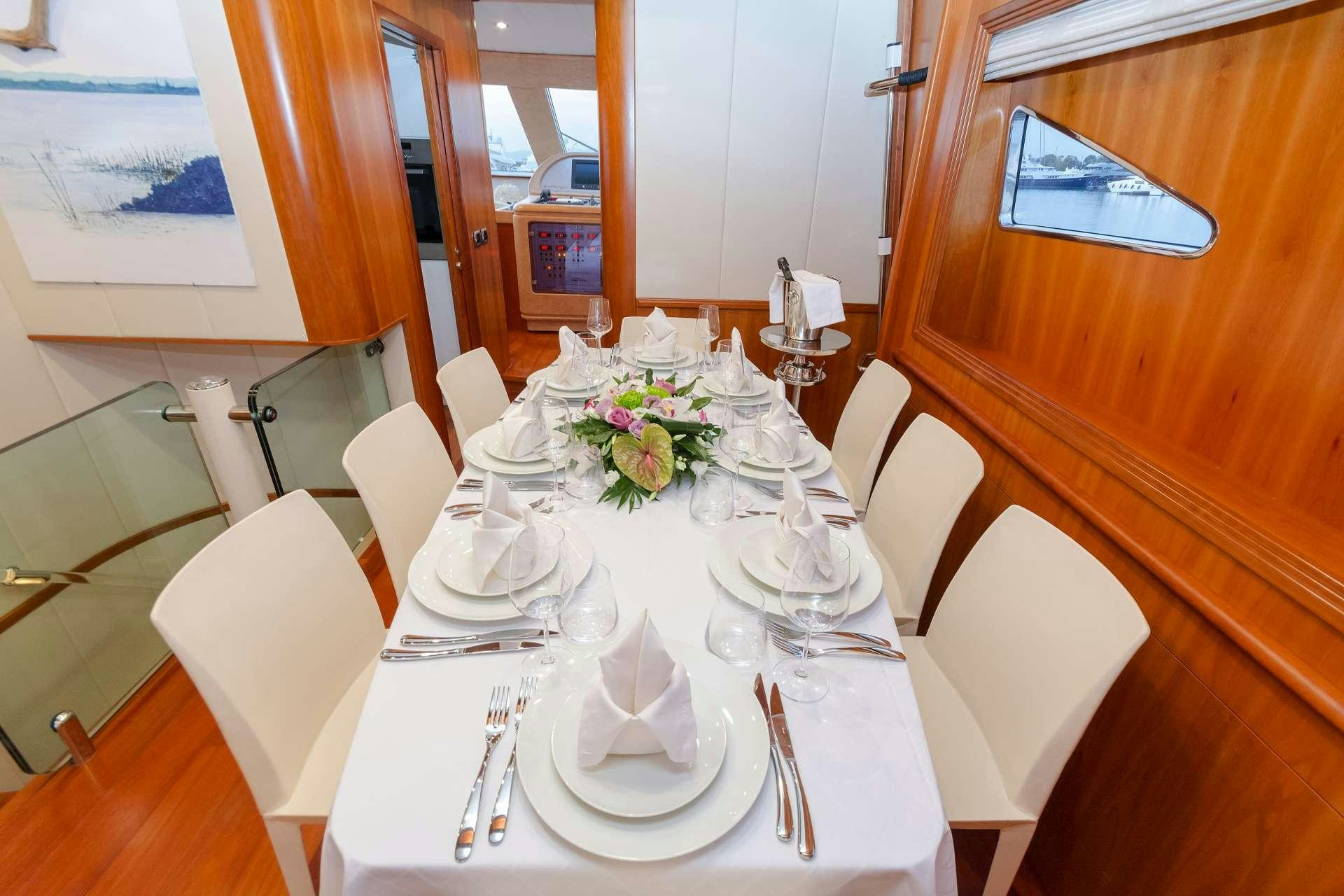 a table set for a dinner aboard ALFEA Yacht for Charter