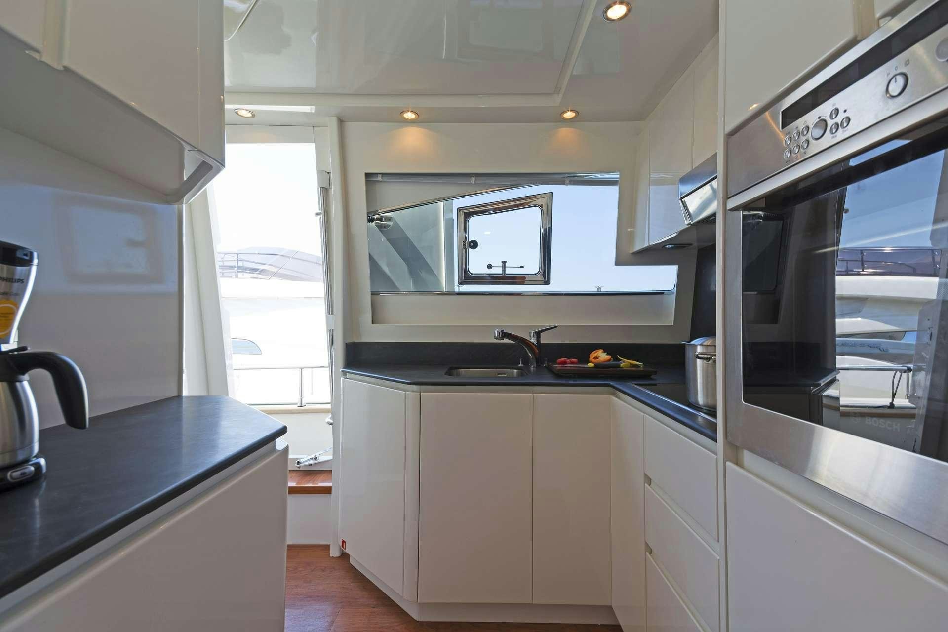 a kitchen with a stove and a microwave aboard ALFEA Yacht for Charter