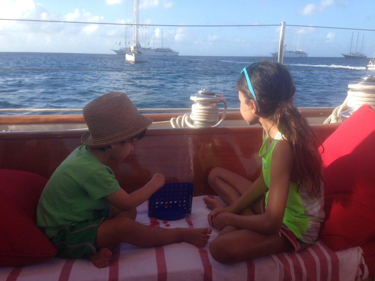 a group of people sitting on a bench looking at a tablet aboard NORTHERN STAR Yacht for Charter