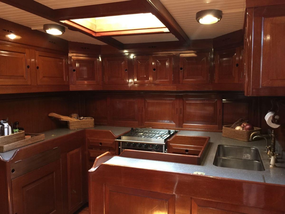 a kitchen with wooden cabinets aboard NORTHERN STAR Yacht for Charter