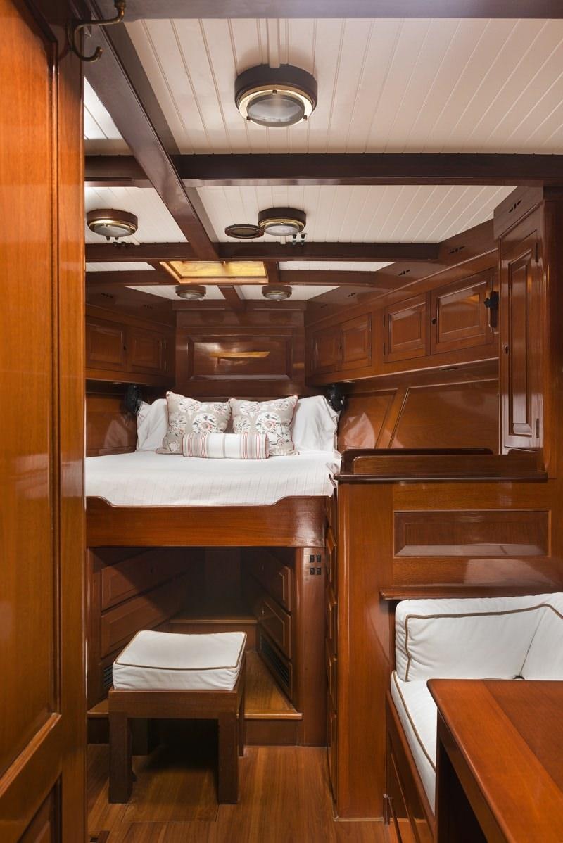 a room with a bed and a table aboard NORTHERN STAR Yacht for Charter