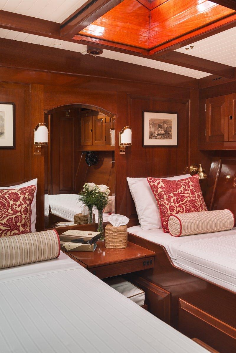 a room with a bed and a mirror aboard NORTHERN STAR Yacht for Charter