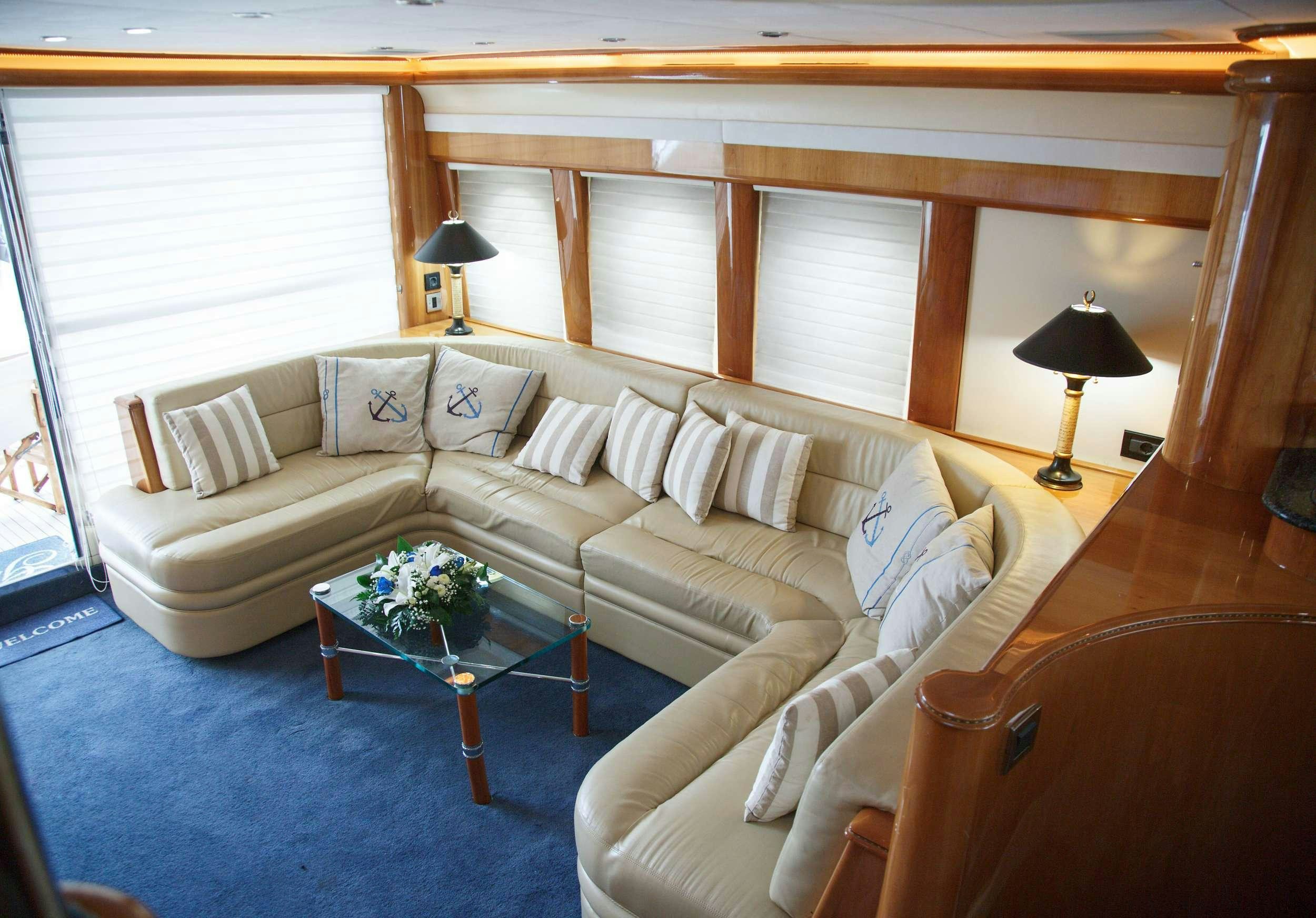 a living room with a couch and a table aboard GODSPEED Yacht for Charter