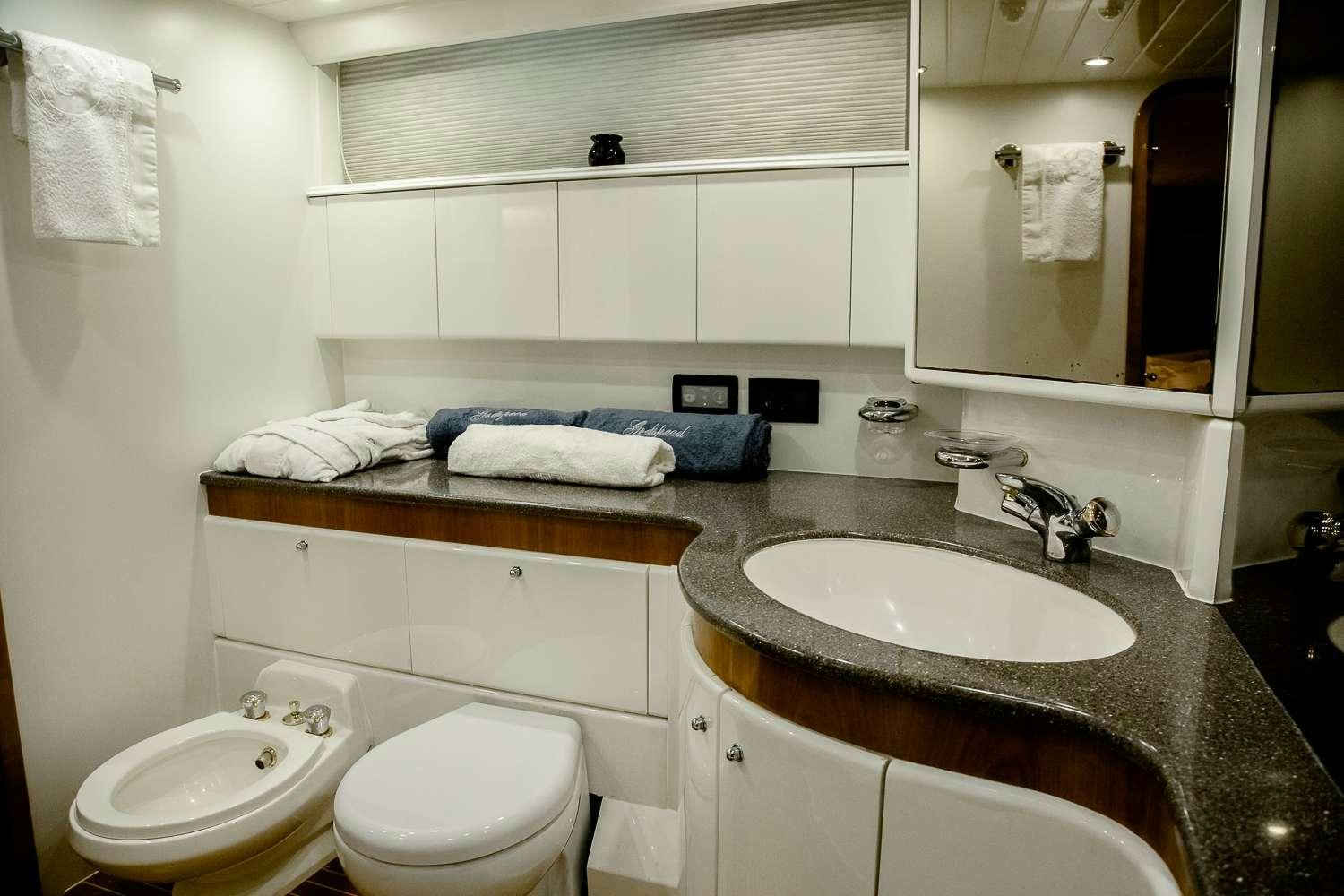 a bathroom with a sink and toilet aboard GODSPEED Yacht for Charter