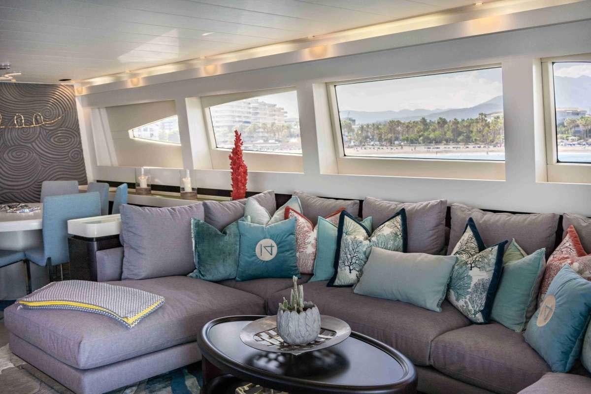 a living room with a couch and a coffee table aboard M Yacht for Charter