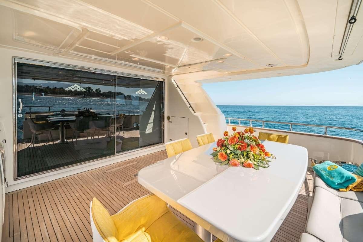 a room with a table and chairs aboard M Yacht for Charter