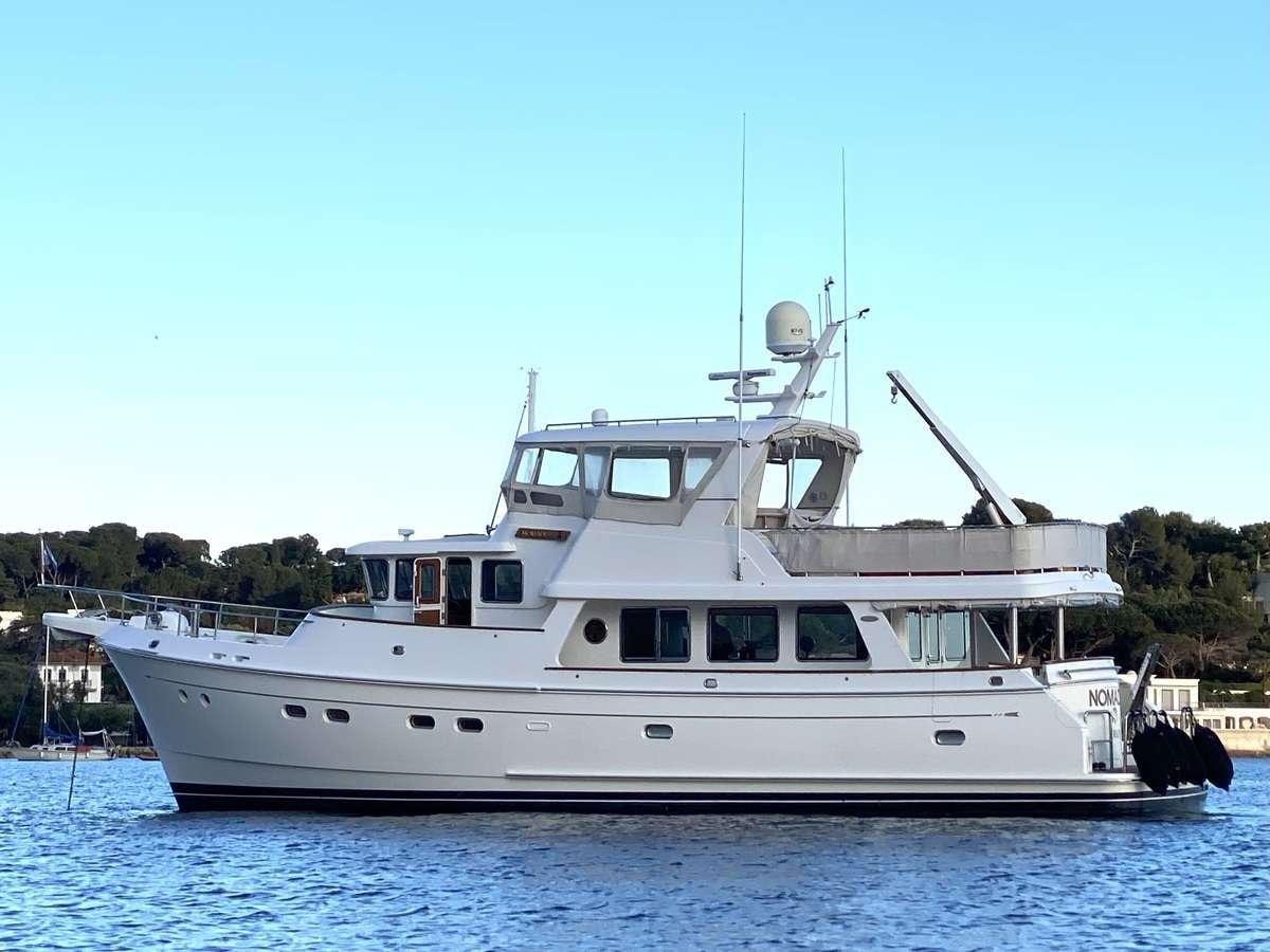 a white boat on the water aboard NOMADES Yacht for Charter