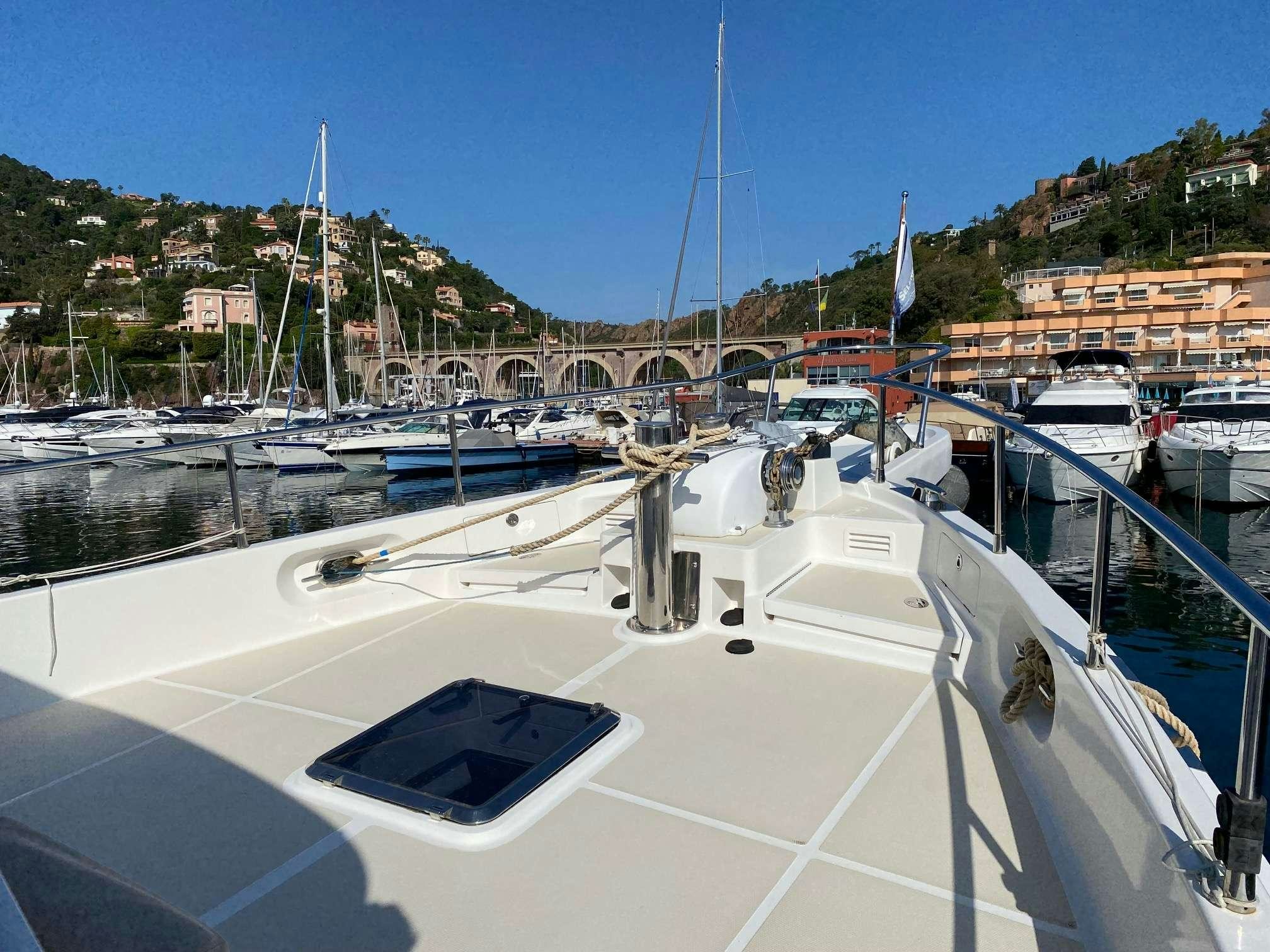 a boat in a harbor aboard NOMADES Yacht for Charter