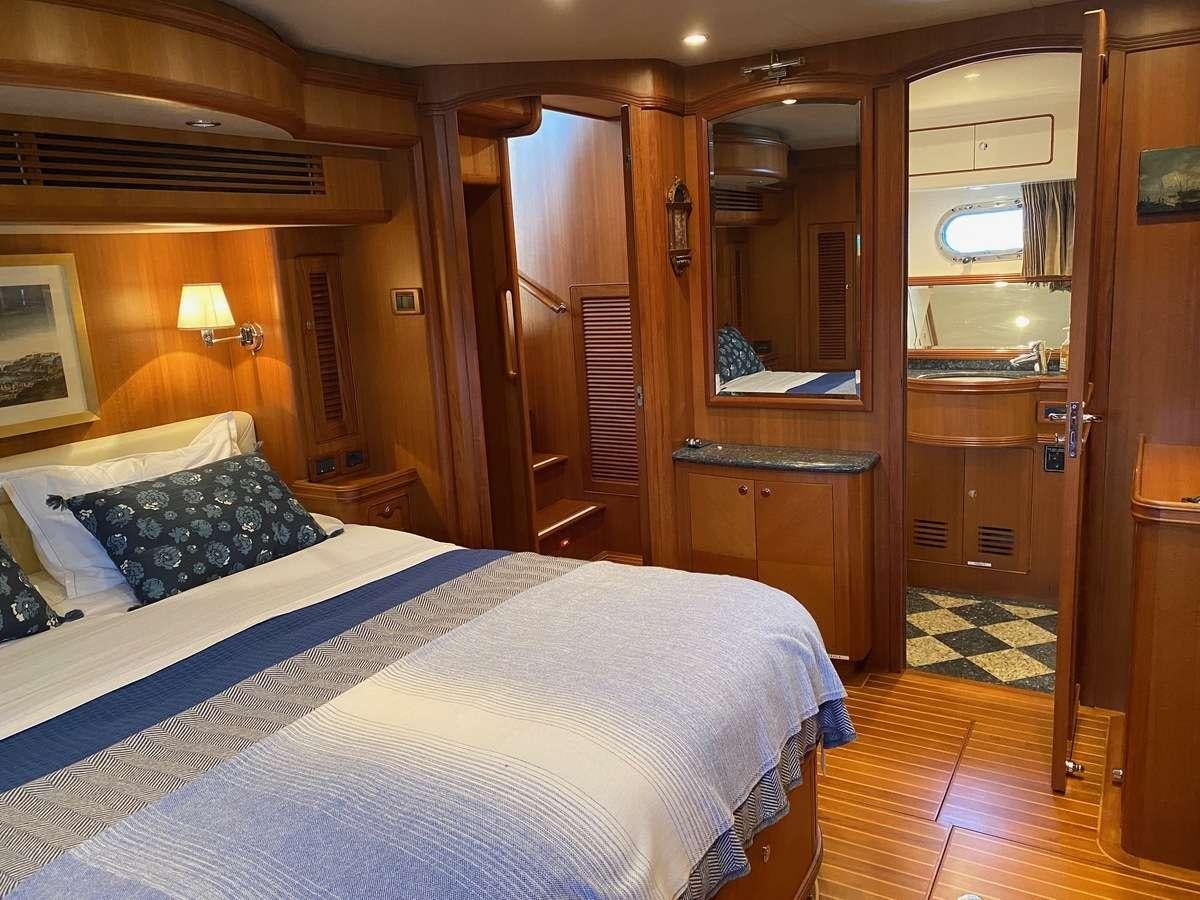 a bedroom with a bed and a closet aboard NOMADES Yacht for Charter