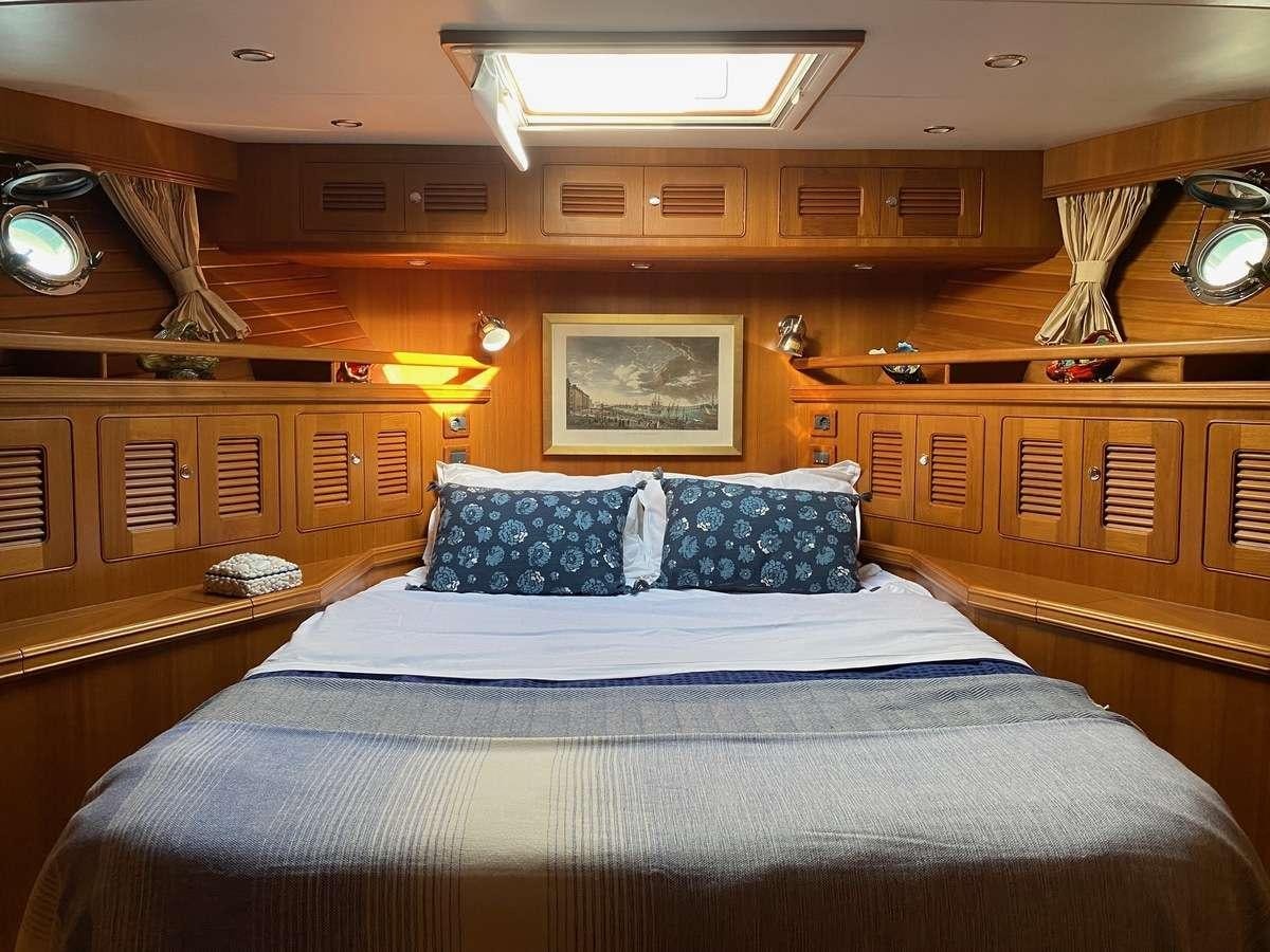 a large bed in a room aboard NOMADES Yacht for Charter