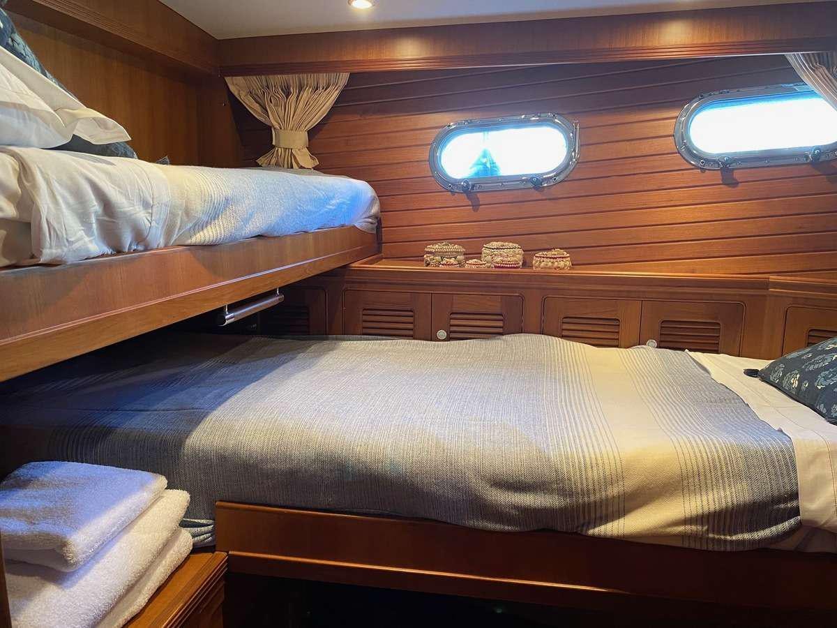 a room with two beds aboard NOMADES Yacht for Charter