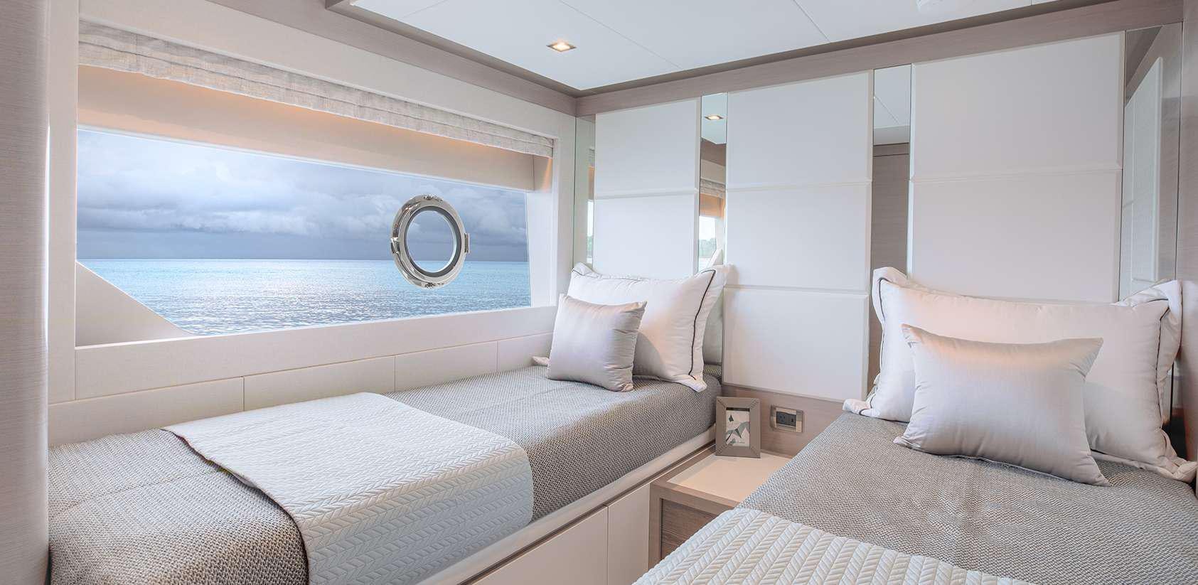 a room with a bed and a large window aboard OCEAN ALEXANDER 27R03 Yacht for Charter